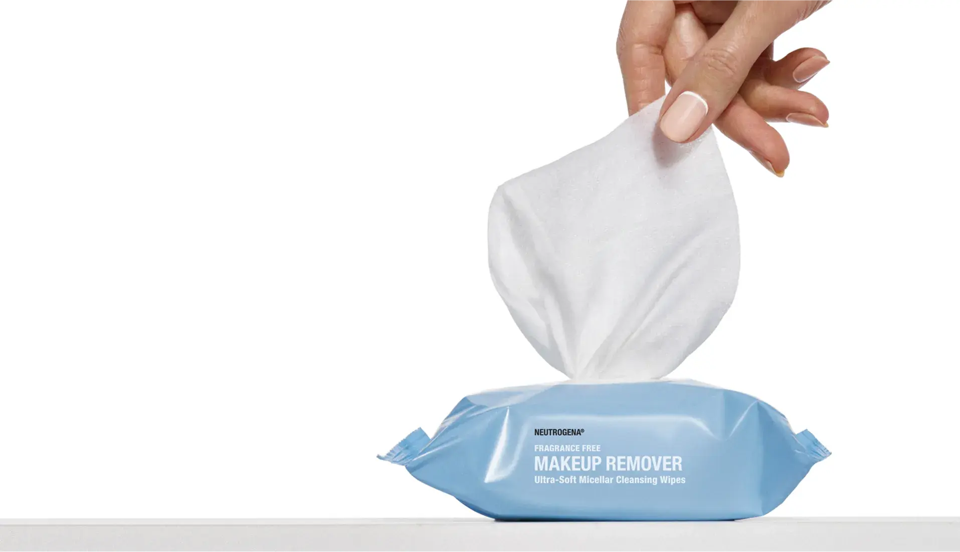 Hand removing wipe from packaging