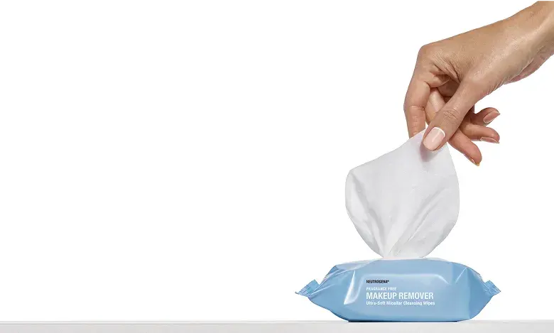Hand removing wipe from packaging, mobile image.