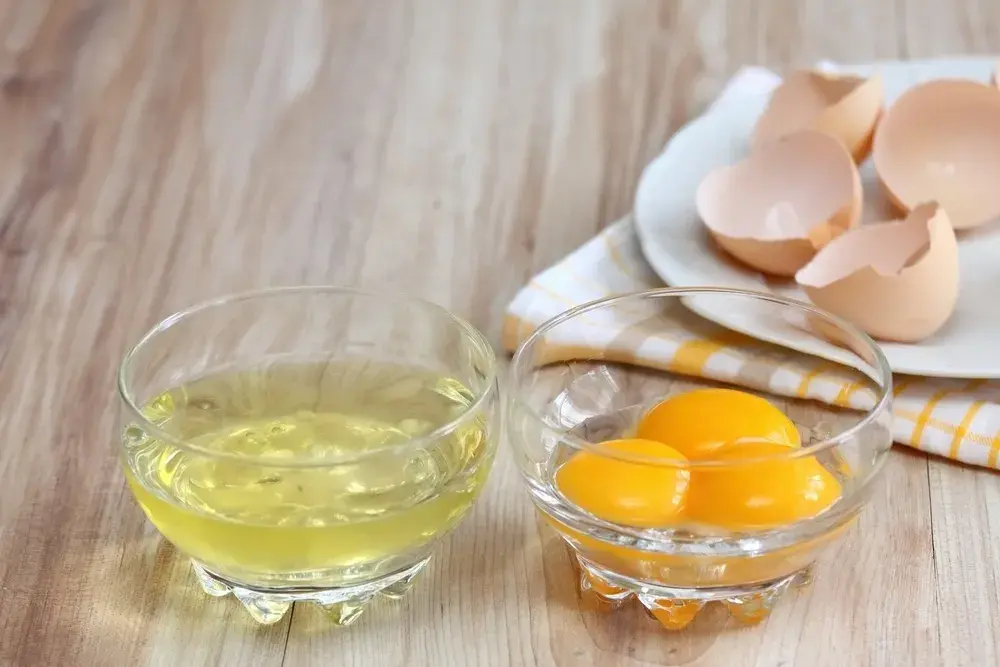 A person separates egg whites.