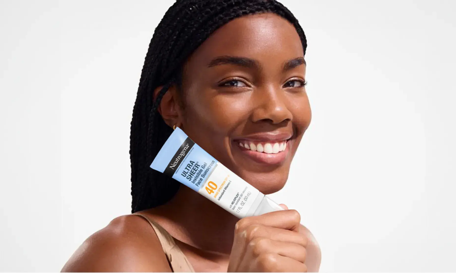 woman smiling holding Neutrogena Ultra Sheer Invisible Gel Face Sunscreen Broad Spectrum SPF 40 for invisible sun protection, premium feel