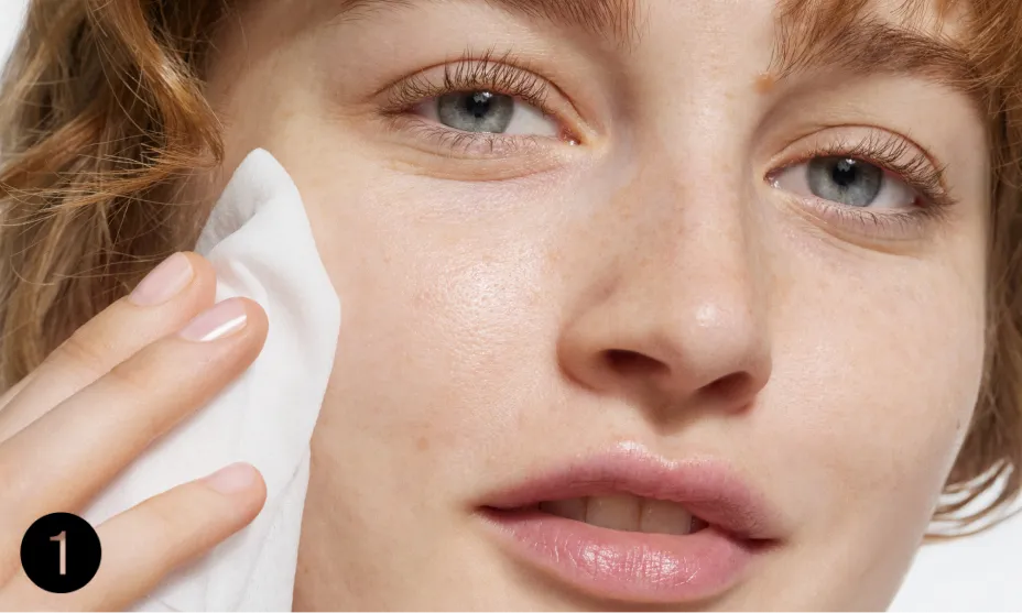 woman pressing wipe to face