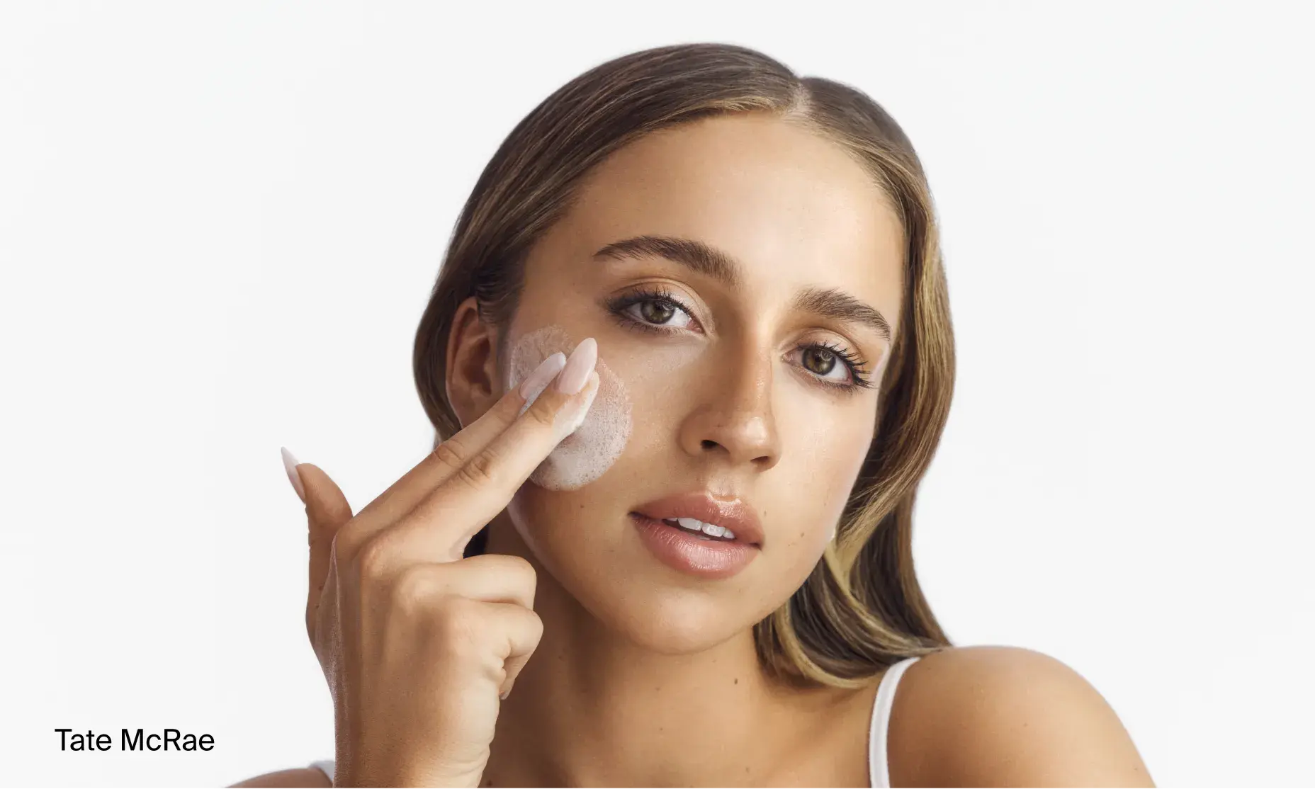 Tate McRae applying Neutrogena® double cleansing duo to face