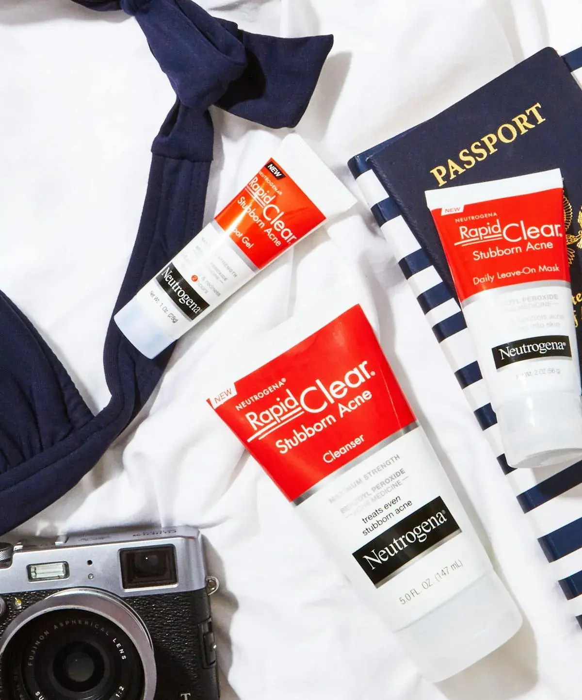 A flat-lay shot of Neutrogena travel essentials on a white surface