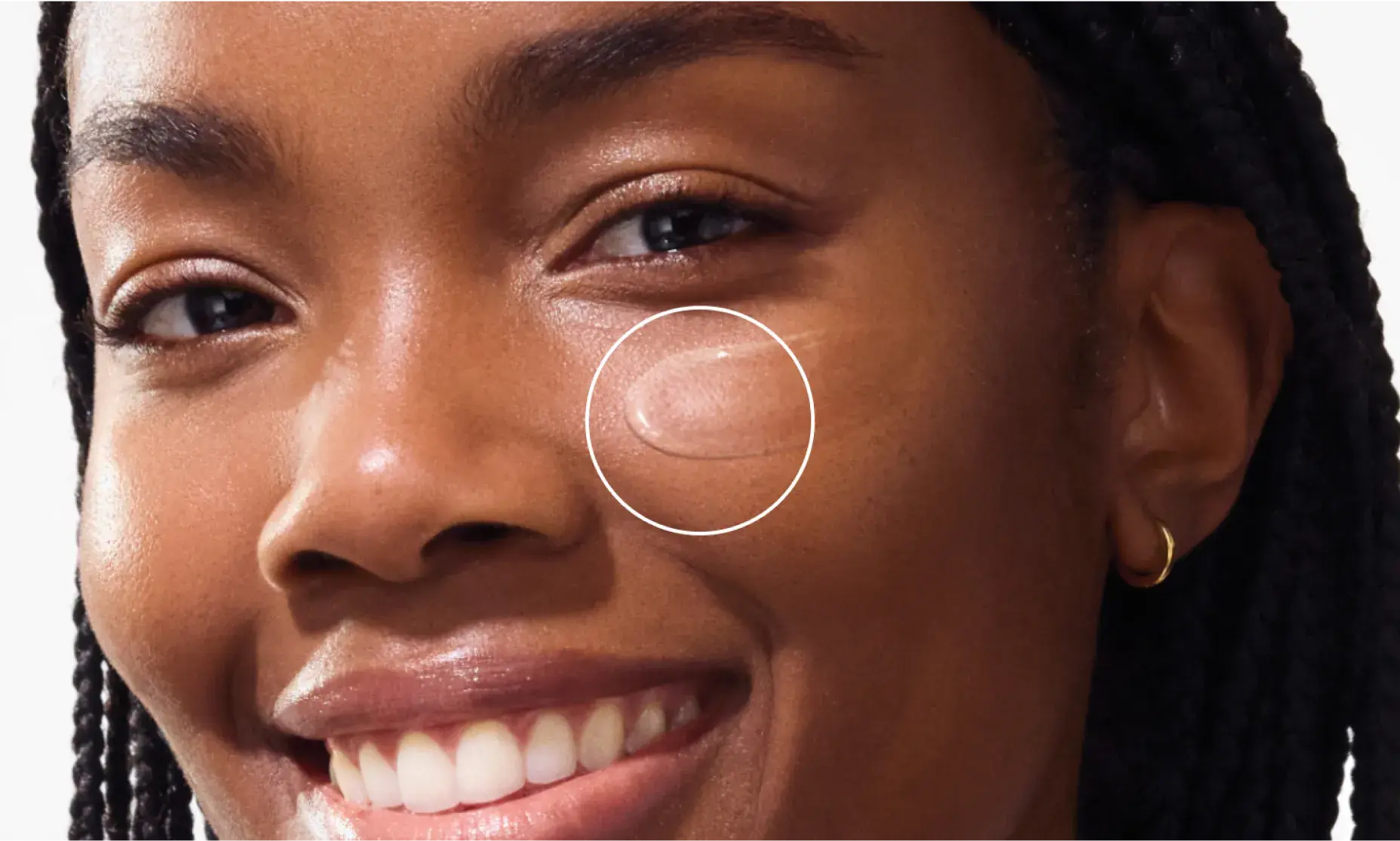 woman smiling applying Neutrogena Ultra Sheer Invisible Gel Face Sunscreen Broad Spectrum SPF 40, 1.7 Oz to cheek