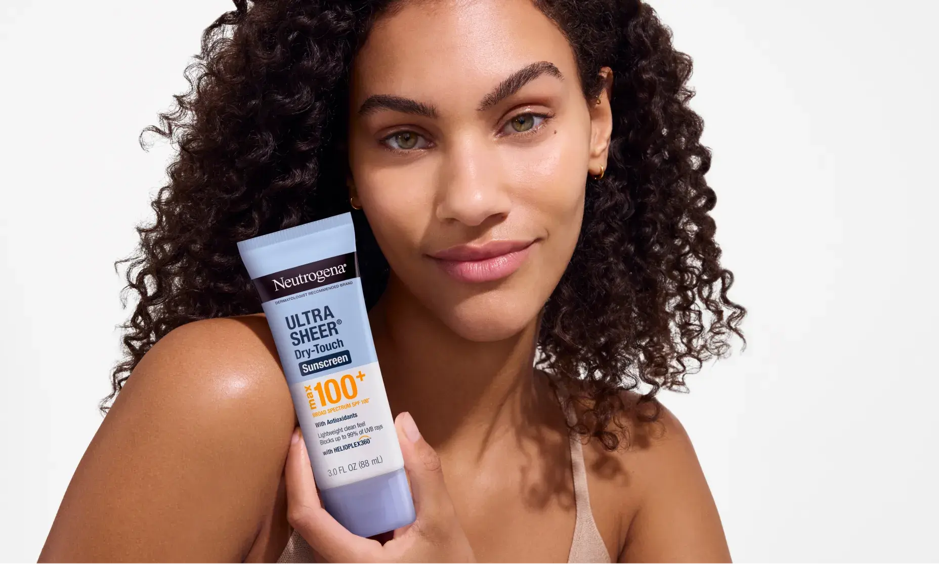 woman smiling holding Neutrogena Ultra Sheer Dry-Touch Broad Spectrum Max SPF 100+ Body Sunscreen, 3 Oz