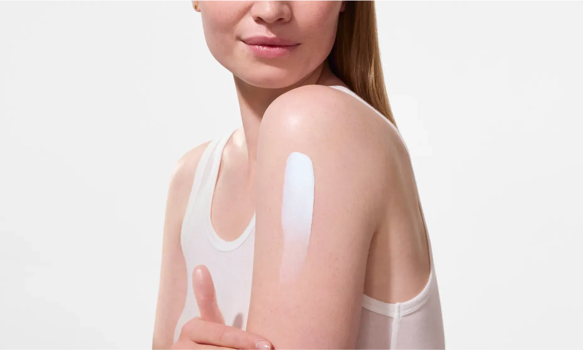 woman applying Neutrogena Ultra Sheer Dry-Touch Broad Spectrum Max SPF 100+ Body Sunscreen, 3 Oz to shoulder