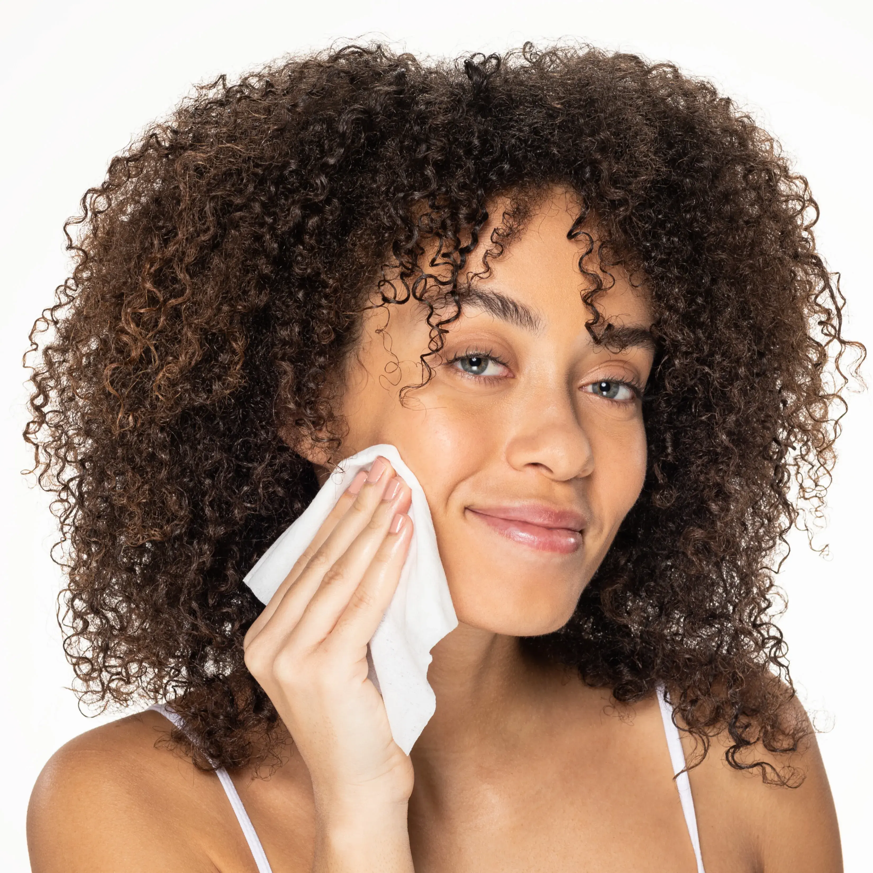 Lady smiling and using Cleansing Wipes on skin