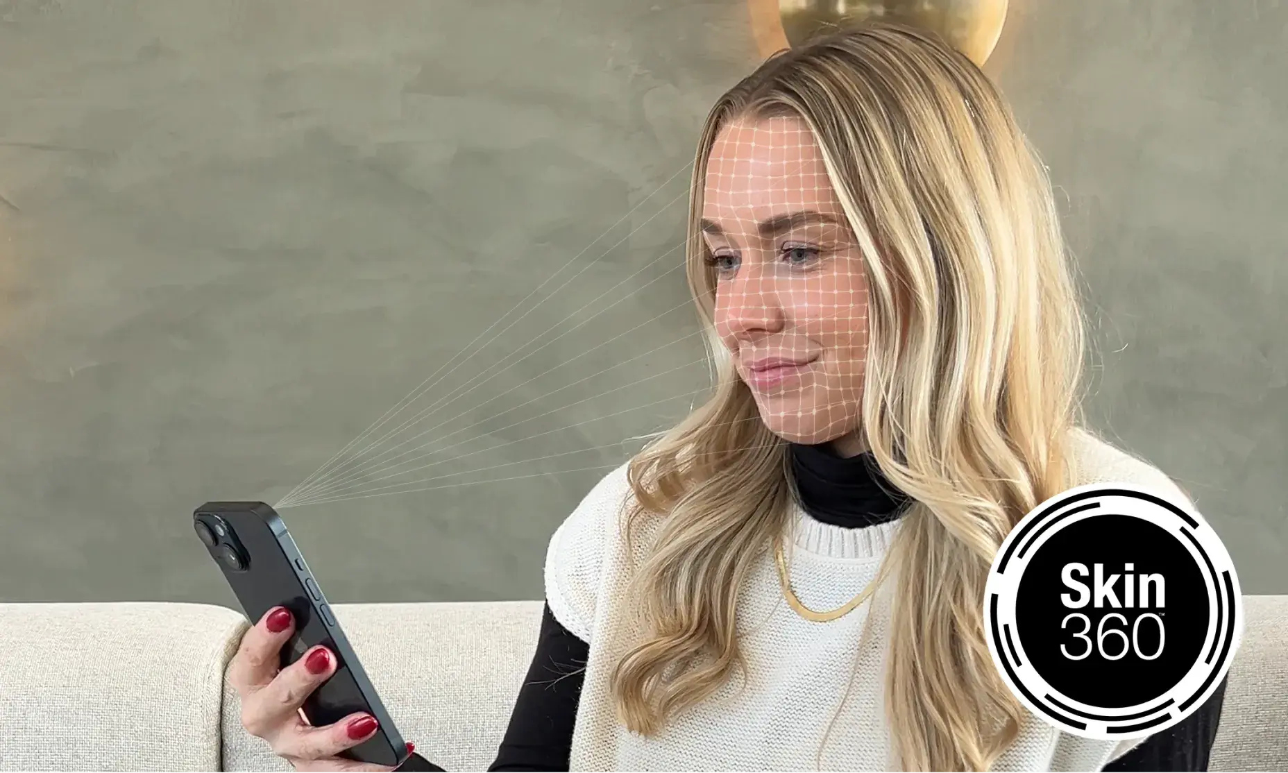 Woman scanning face with Neutrogena® Skin360 tool