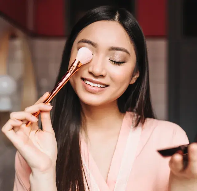 Close-up of a woman applying eyeshadow. 