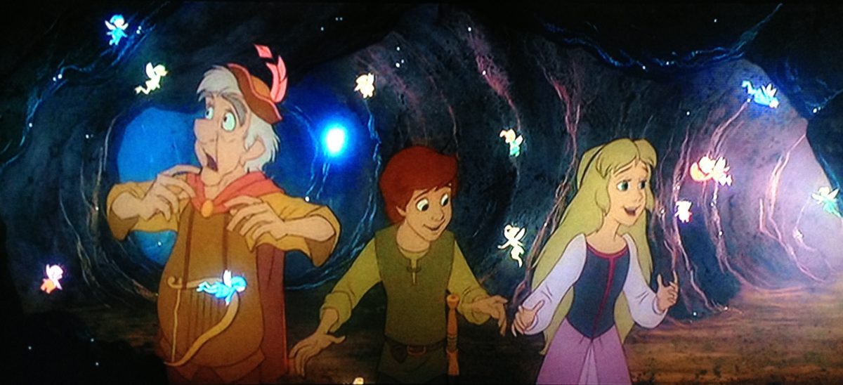 Fflewddur Fflam, an old white man with white hair and eyebrows, wearing a brown tunic, orange cape, brown hat with a pink feather, stands next to Taran, a young white boy with auburn hair, a green tunic and green tabard, and Eilonwy, a young white girl in a purple dress with a blue bodice and blonde hair.  They are surrounded by glowing tiny fairies and they're in a cave.