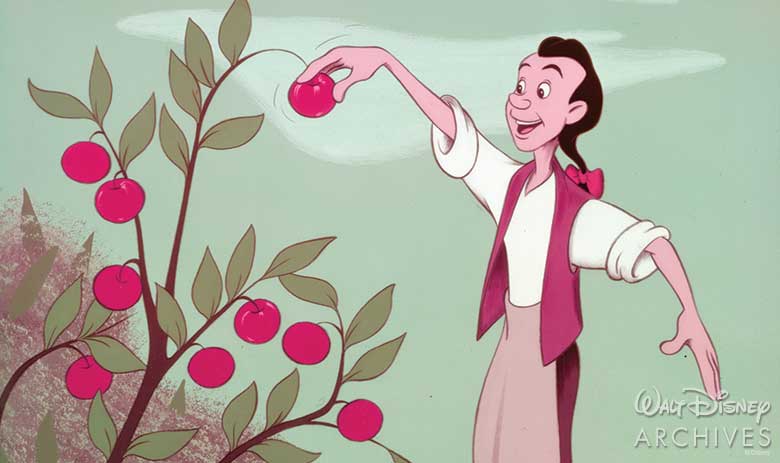 Johnny Appleseed, a thin white man with long brown hair in a ponytail with a bow, wearing a white shirt with the sleeves rolled up, red vest, and tan pants, picks a red apple off an apple tree in front of a blue-green sky with a cloud in it.