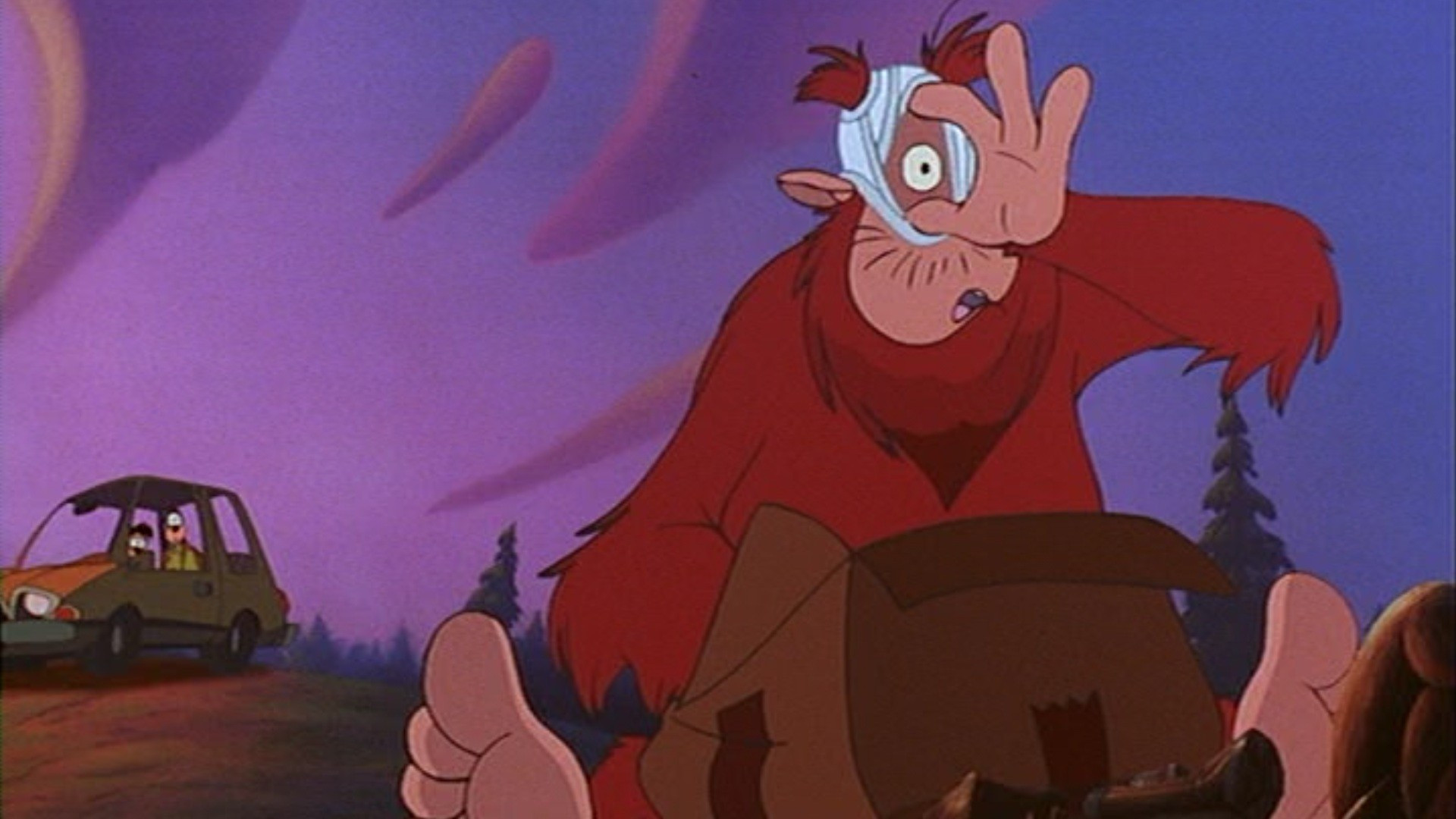 Bigfoot, a giant humanoid creature with red fur, sits in front of a cardboard box with a downward pointing  arrow on the side, wearing a pair of white men's briefs underwear on his head.  He holds the crotch hole open with his fingers so he can look out.  Goofy, a dog-like humanoid cartoon with black skin and a pale face, and long ears, watches from his yellow car several hundred feet behind Bigfoot, with his son Max in the passenger seat; Max looks similar to Goofy.