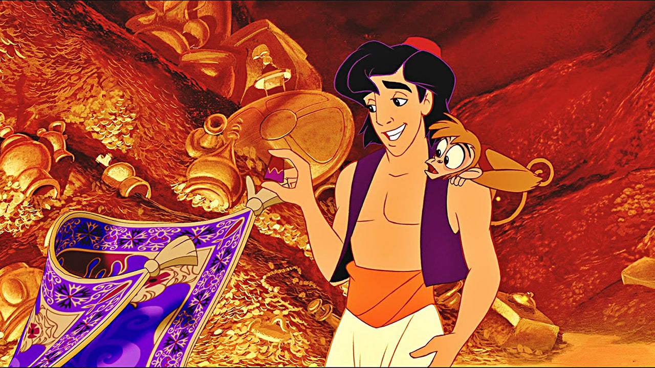 A purple, elaborate carpet holds two of its arms (tassels) out to Aladdin, a slightly tanned young man with black hair, wearing a purple vest, orange waist sash, white pants and a small red fez. On his shoulder is Abu, a monkey, wearing a red vest.  They all stand in front of piles of gold and treasure.