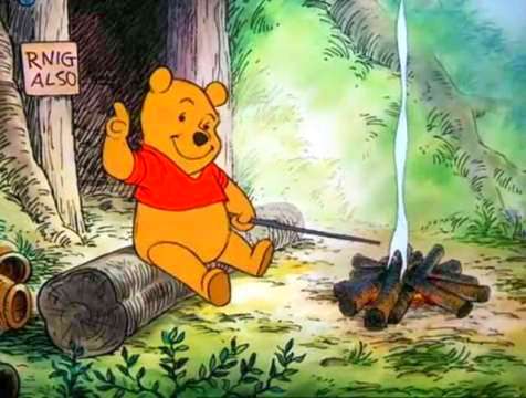 Winnie the Pooh, an orange stuffed bear in a red shirt, sits on a log outside a wooden entryway, with a sign that says "RNIG ALSO".  In front of him is a campfire with a small smoke cloud rising from it, and he's holding a stick towards the fire, and pointing at the "RNIG ALSO" sign.