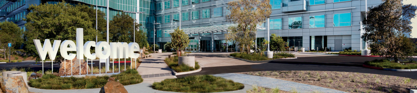 Large modern glass building with welcome sign in the front