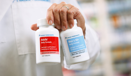 Pharmacist holding two pill bottles