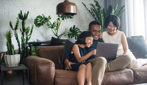 Family in front of laptop computer. 