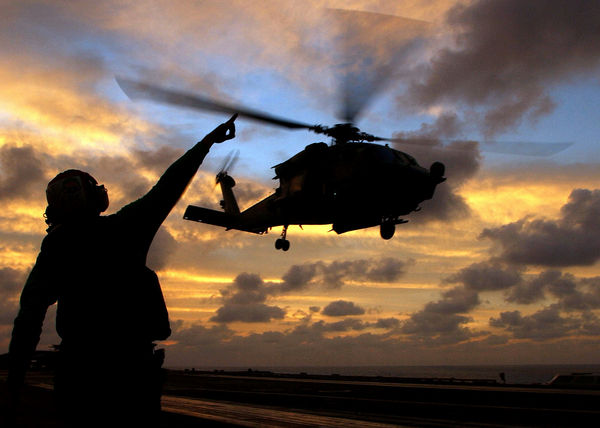 aviation-electricians-mate-airman-john-broughton-signals-to-an-hh-60h-seahawk-helicopter-as-it-takes-off l