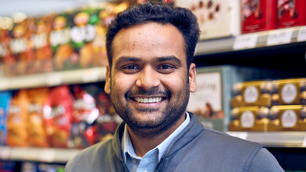 A close up of a Co-op employee smiling