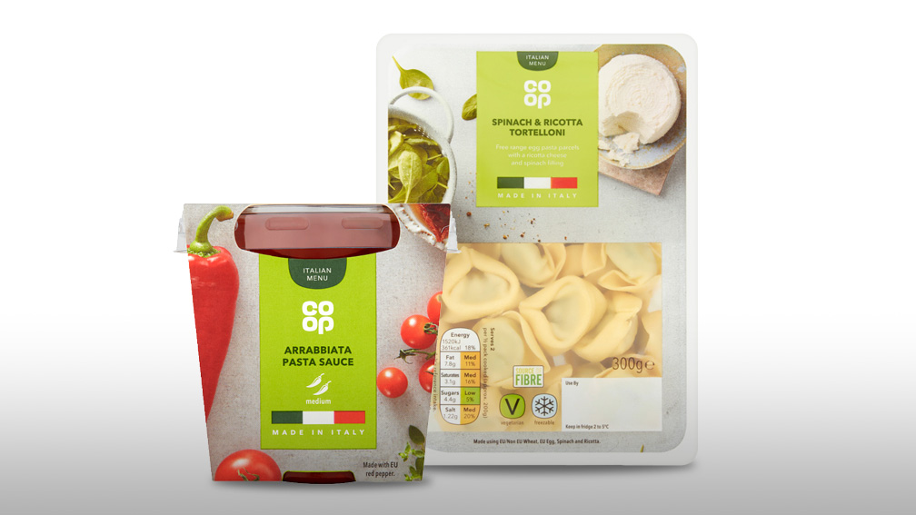 Packaging for ready made pasta and sauce against a white background.