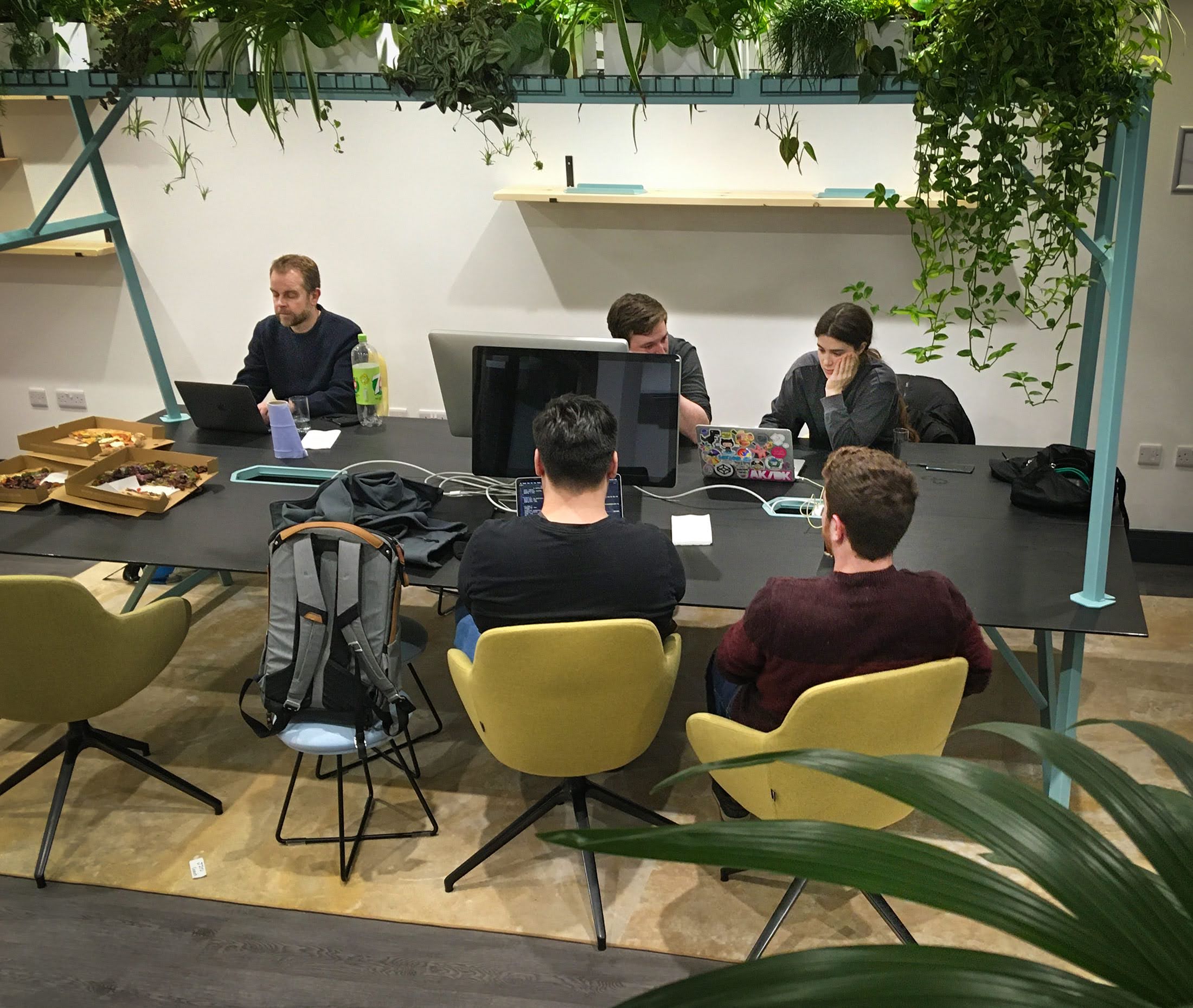 A group of people working on their laptops attending a MPB and codebar event in Brighton. 
