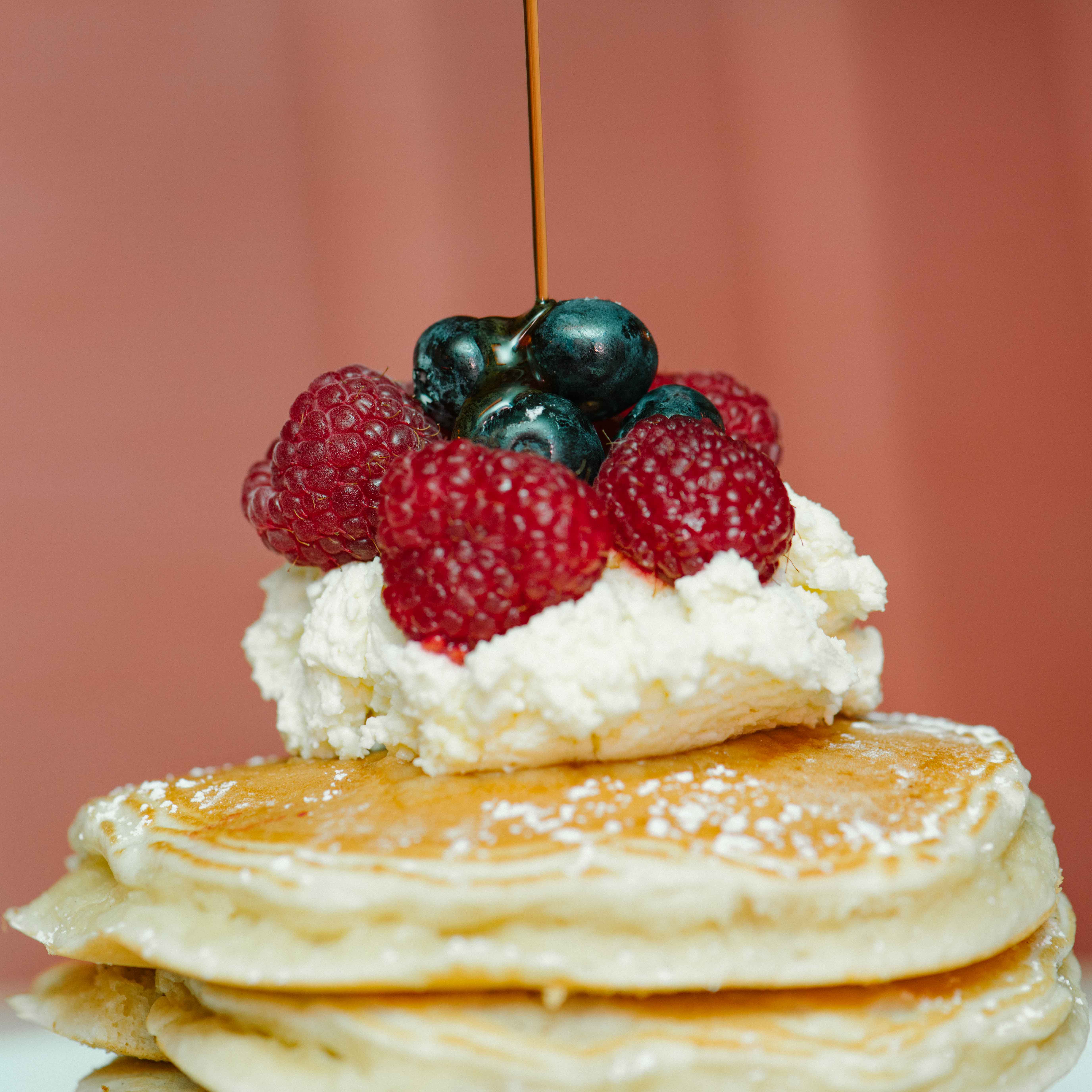 Lighting bouncing off blueberries on a stack of pancakes. Taken with a Nikon setup.