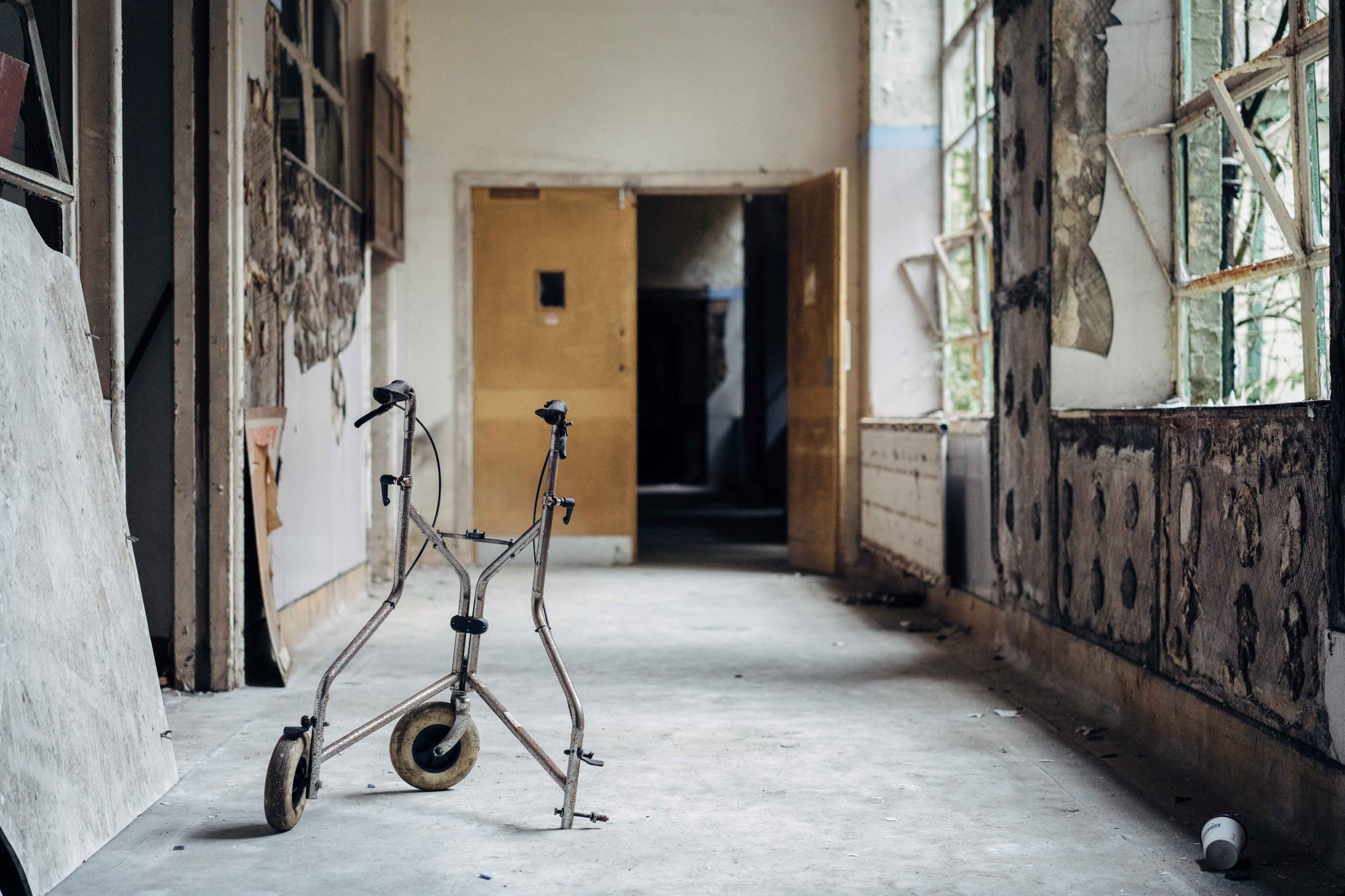 An old walking aid in a derelict hospital hallway