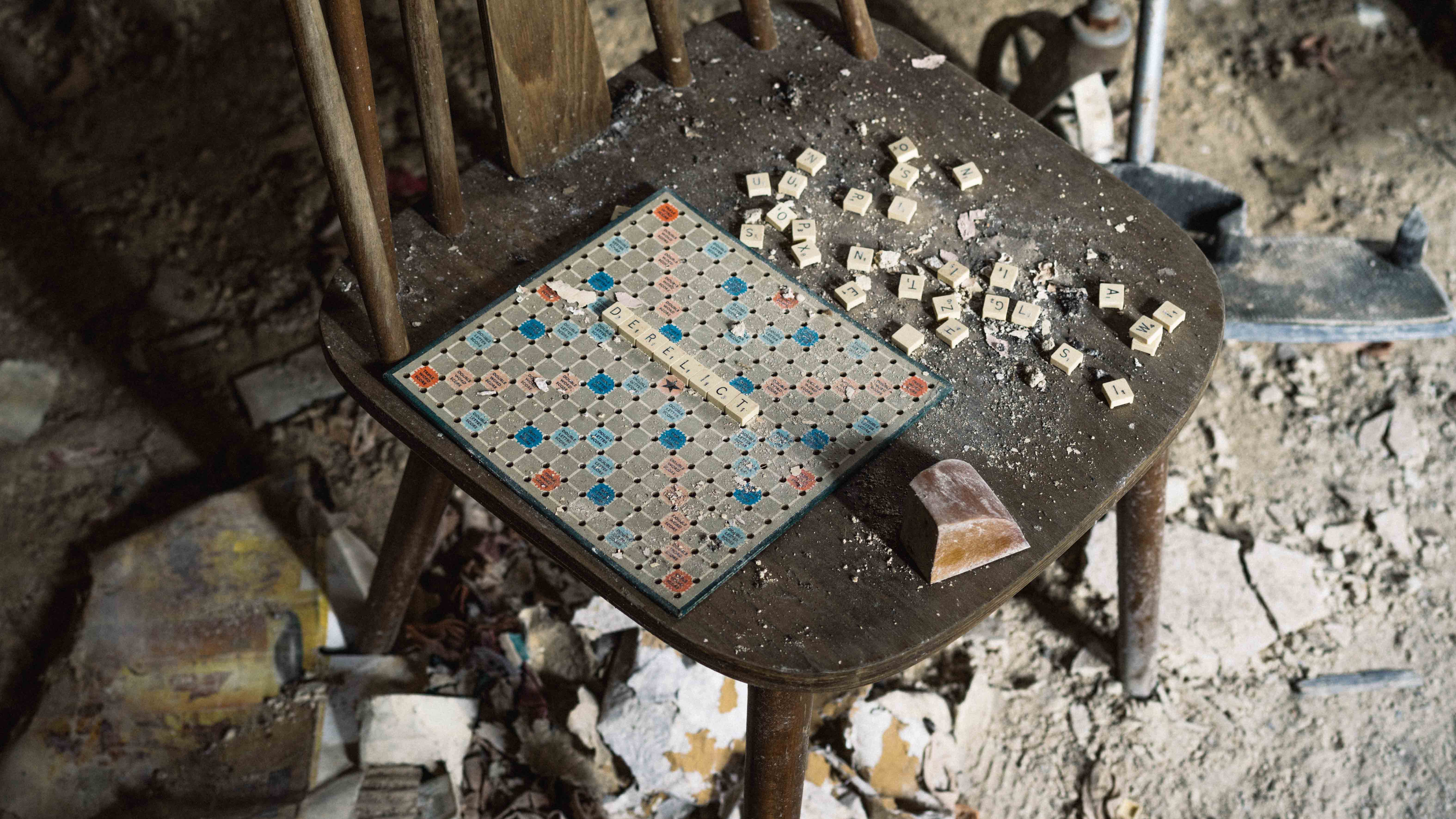 Photo of light bursting through a window in an abandoned house, revealing a wheelchair 