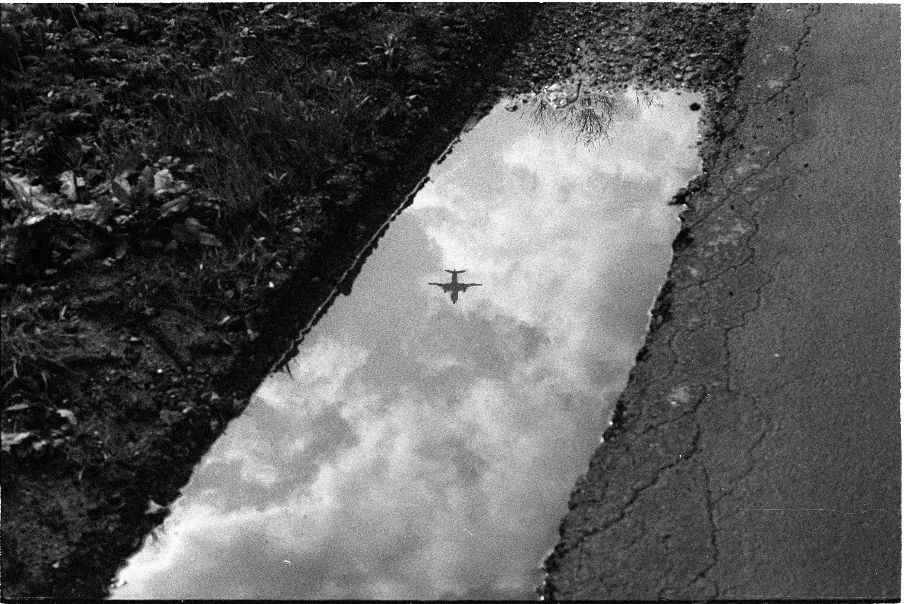 Reflection of an aeroplane in a puddle, shot with Leica MP with Adox Silvermax 100 film
