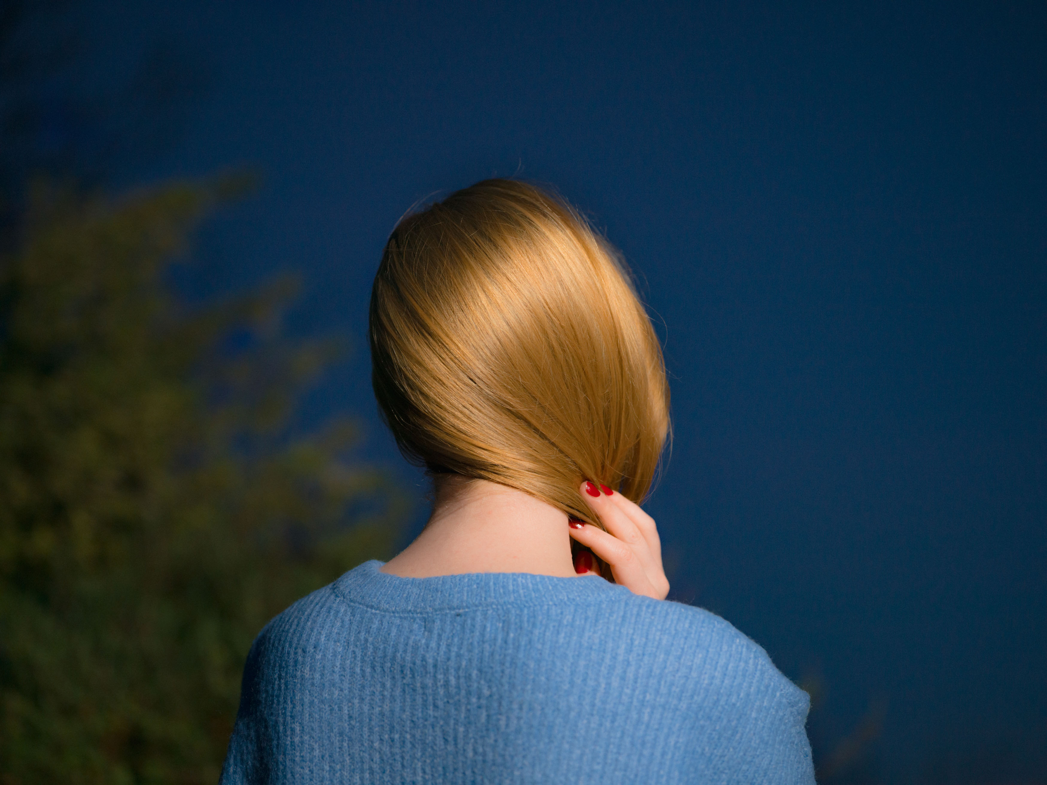 A blonde girl photographed from behind