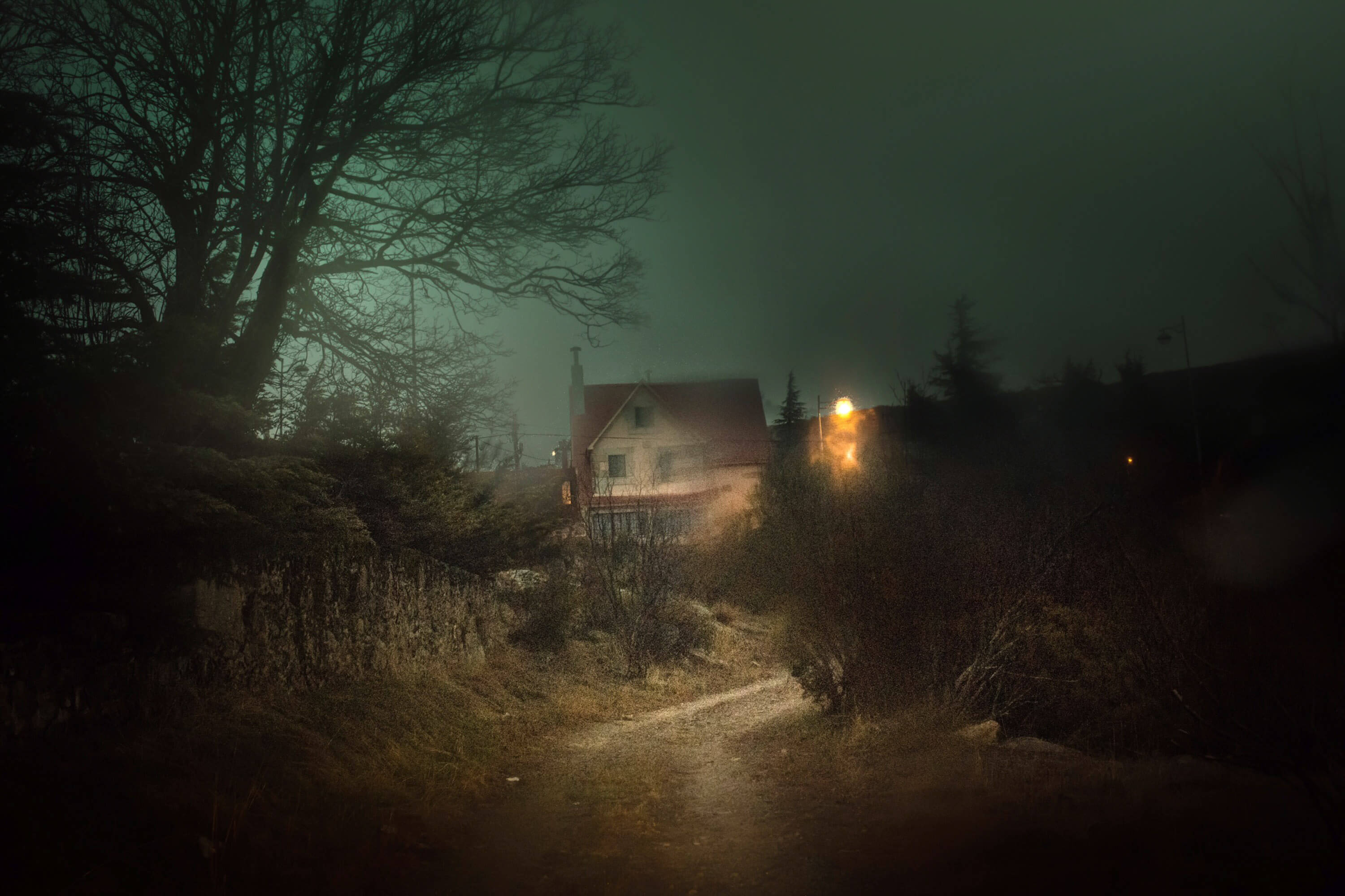 a house in the distance under misty conditions