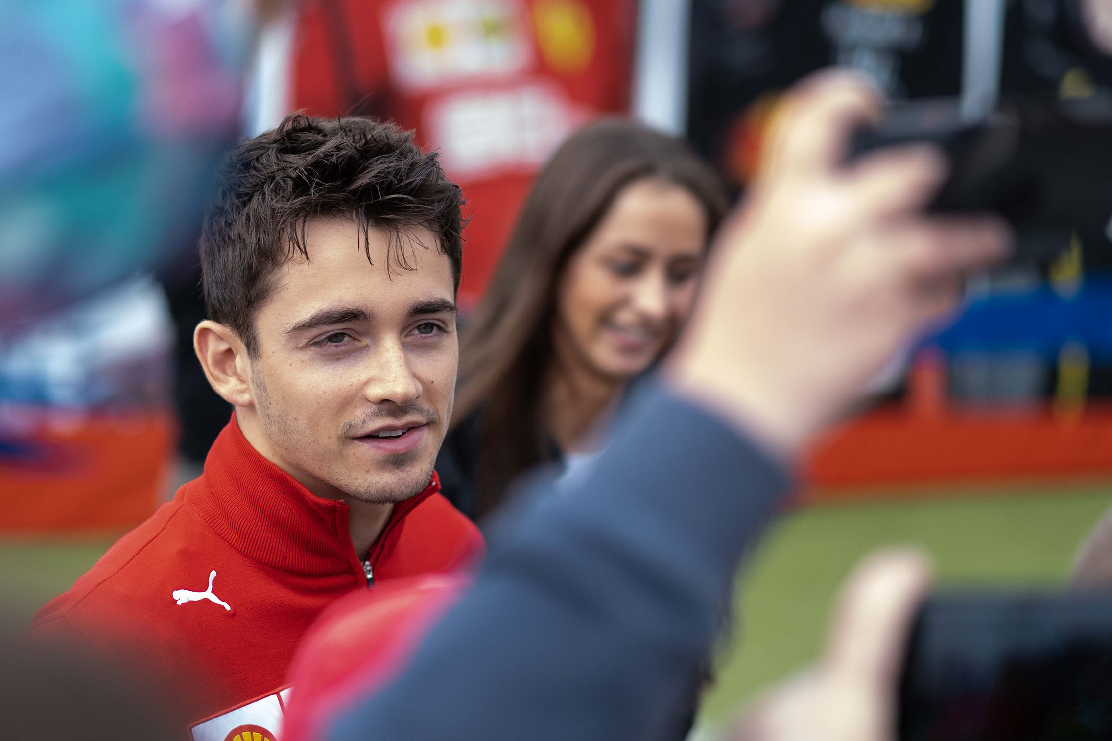A race car driver having photos taken