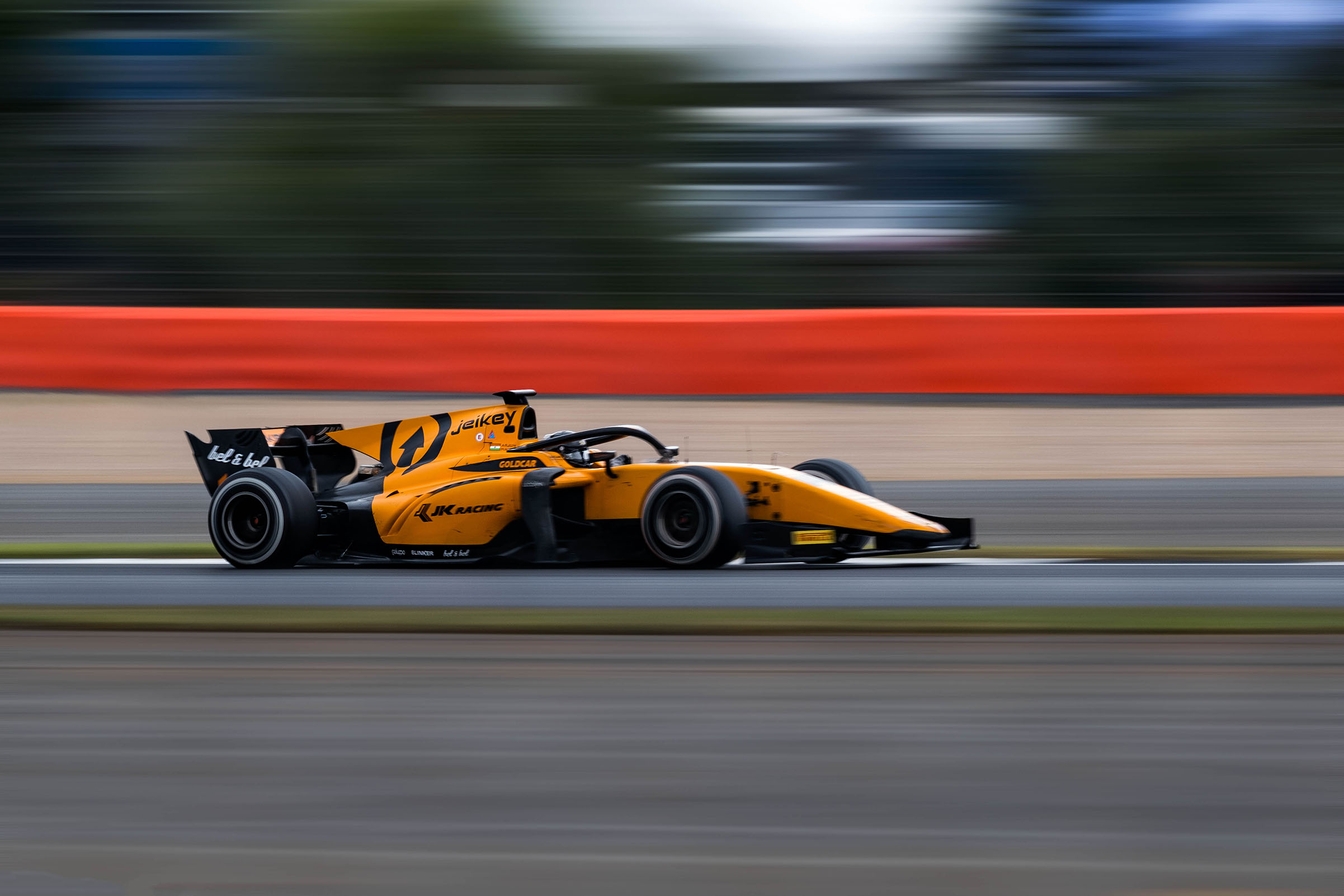 an orange race car with motion blur