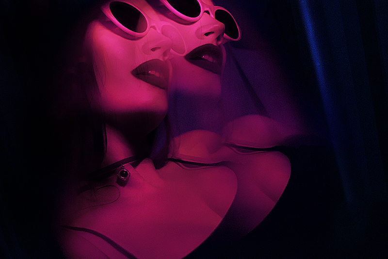 A double exposure of a girl in sunglasses indoors.