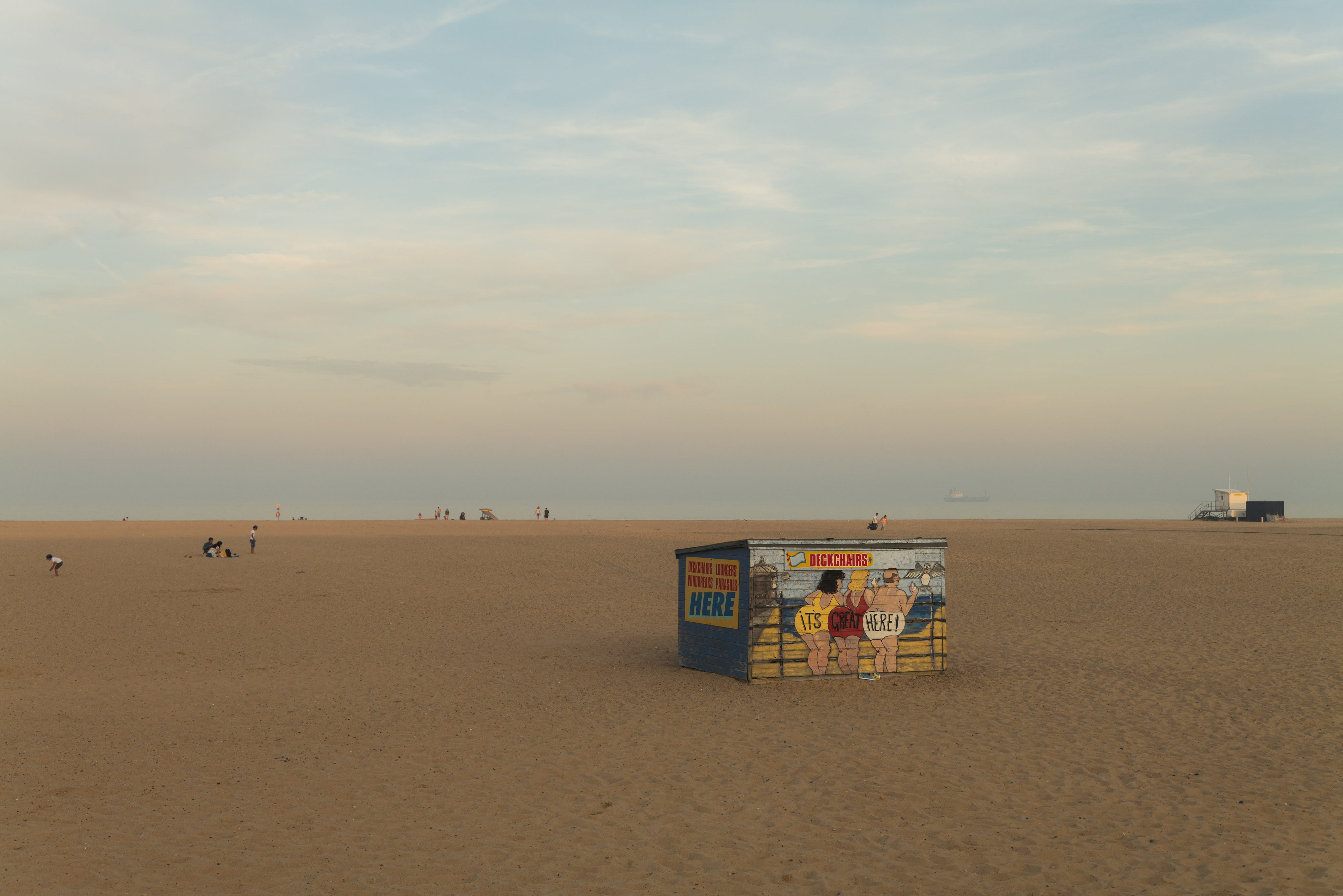 A beach, with a beach chair storage unit in foreground