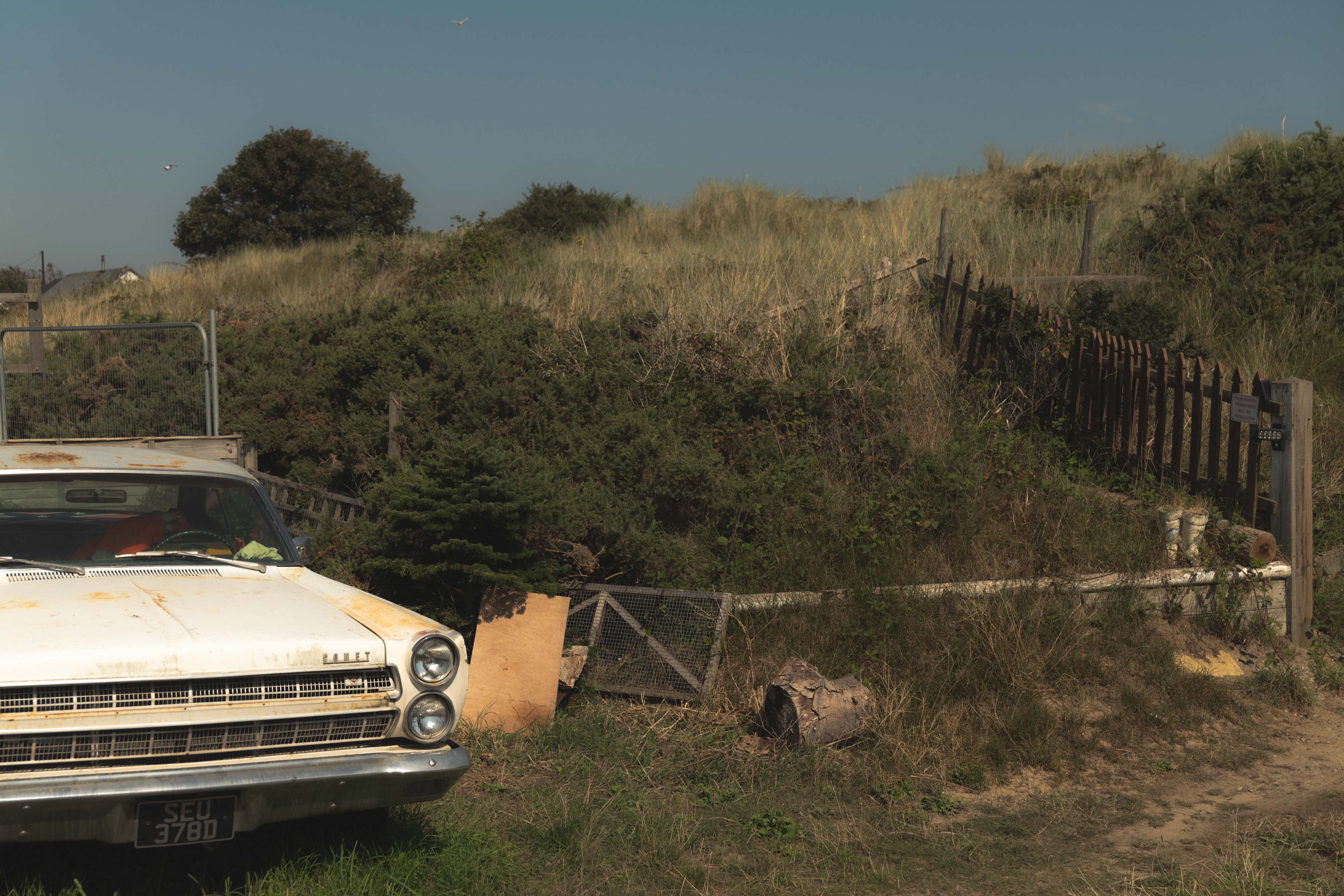 a desolate area with an old fashioned car