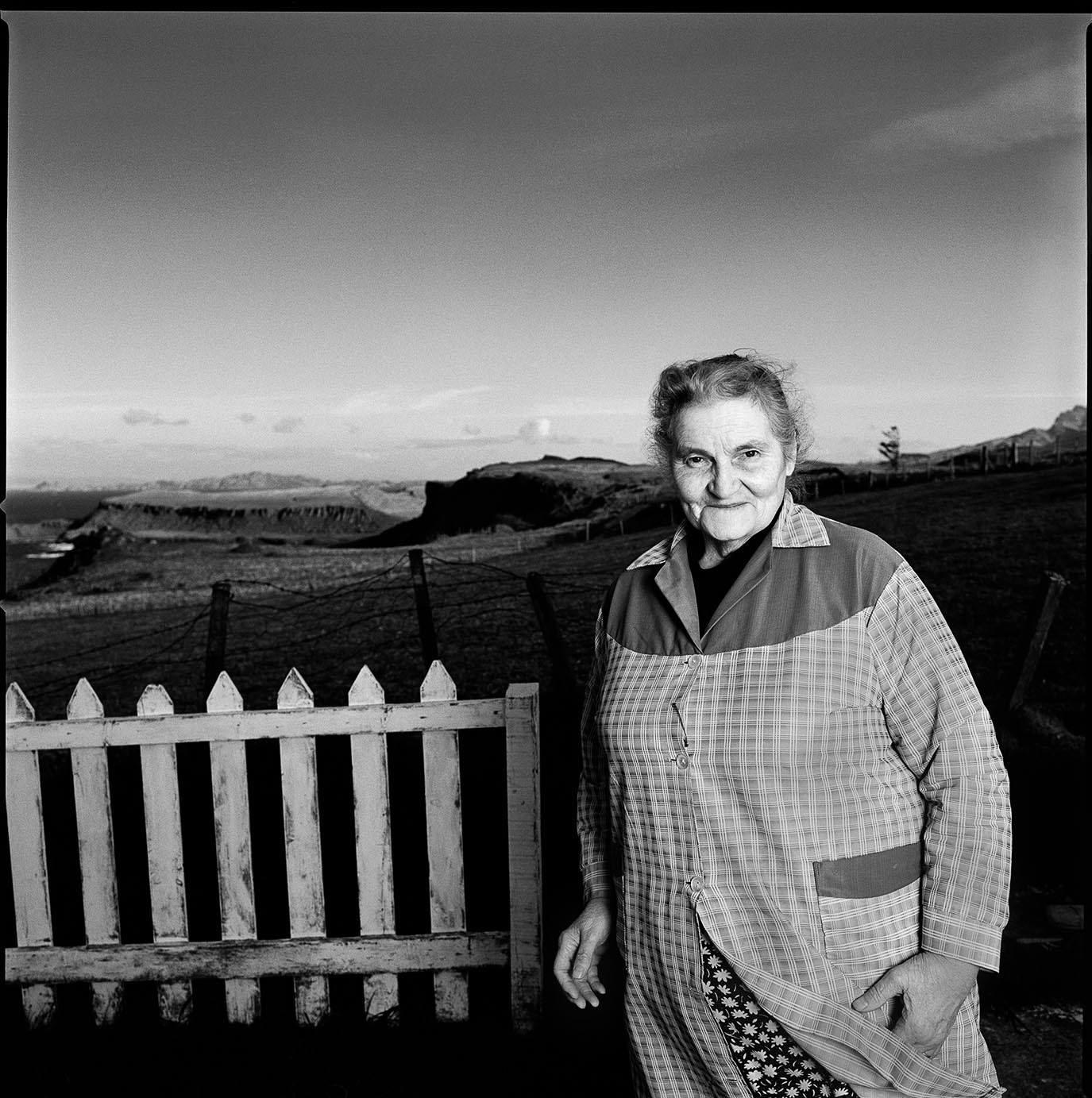 Black-and-white photo of an elderly person on a farm