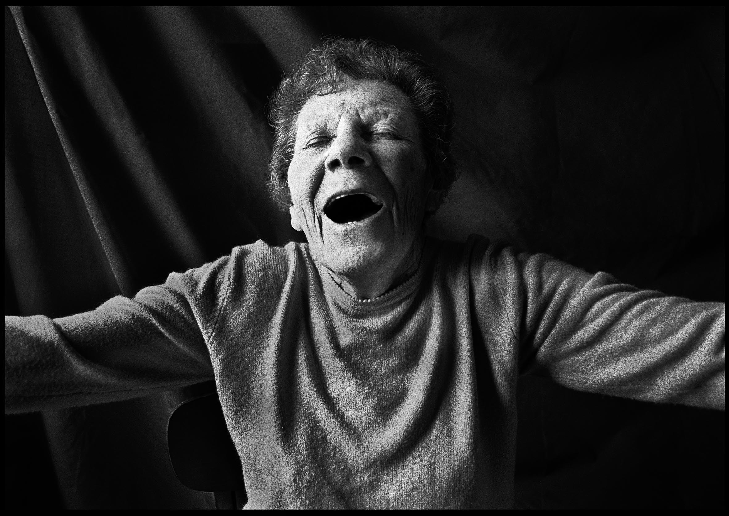 Black-and-white photo of an elderly person filled with joy