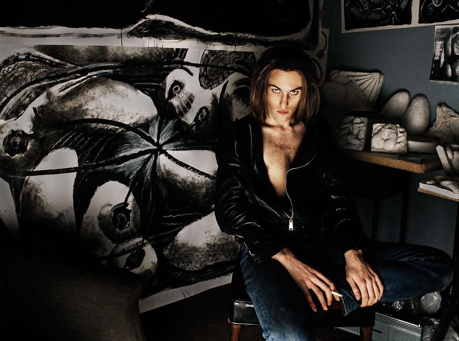 Colour portrait of a person sitting on a stool