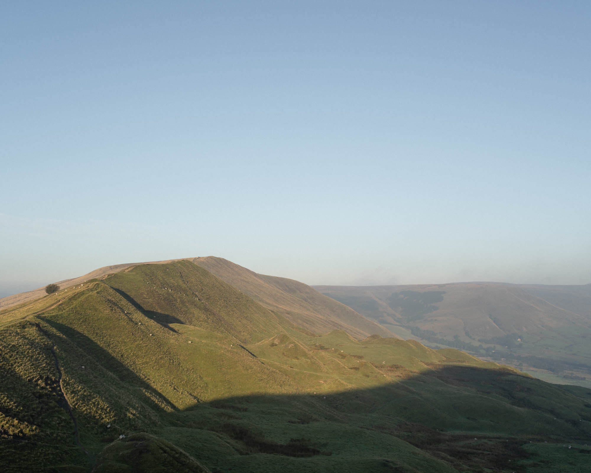 Large mountain covered in green grass