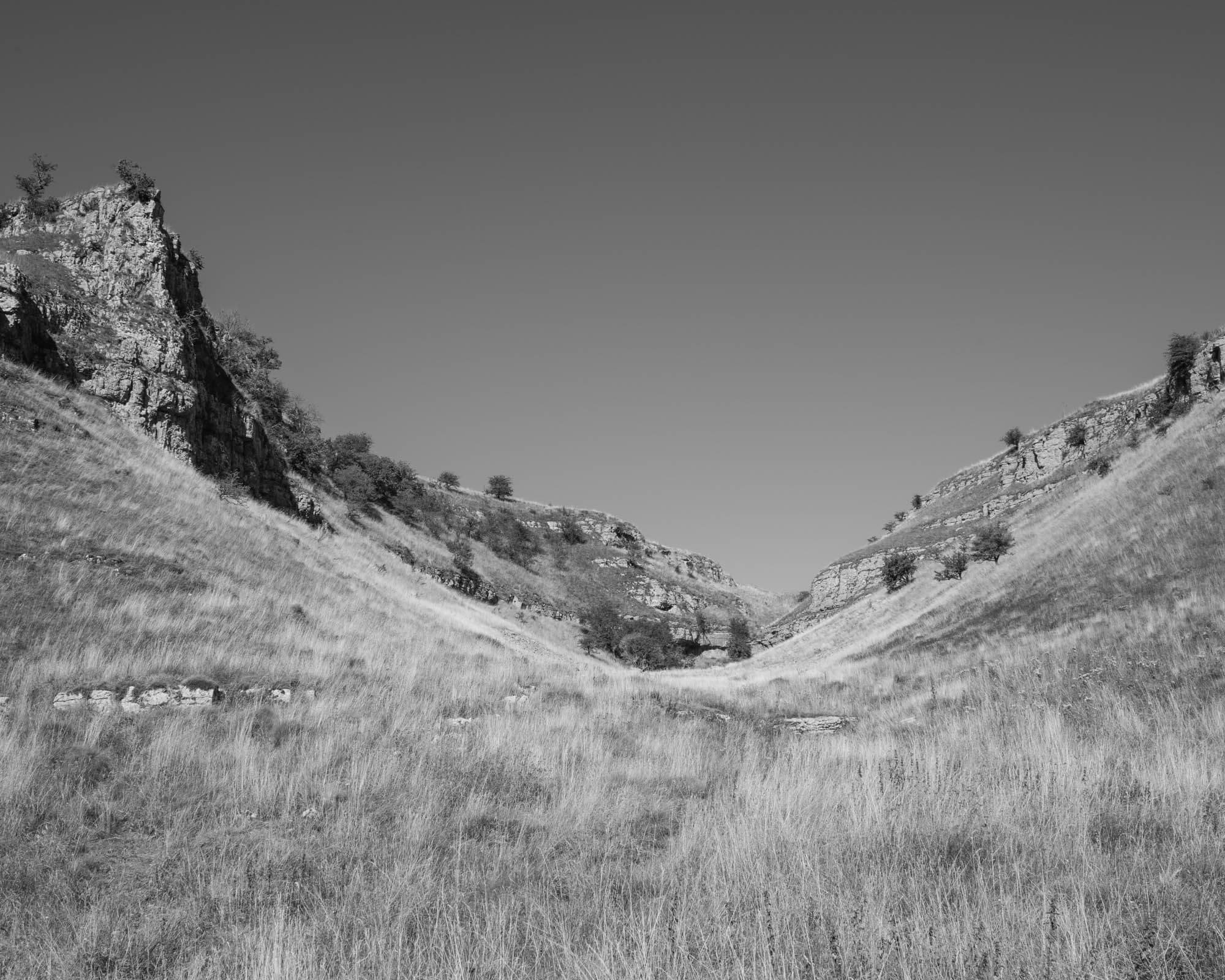 Black and white image of a 'U' shaped hill valley