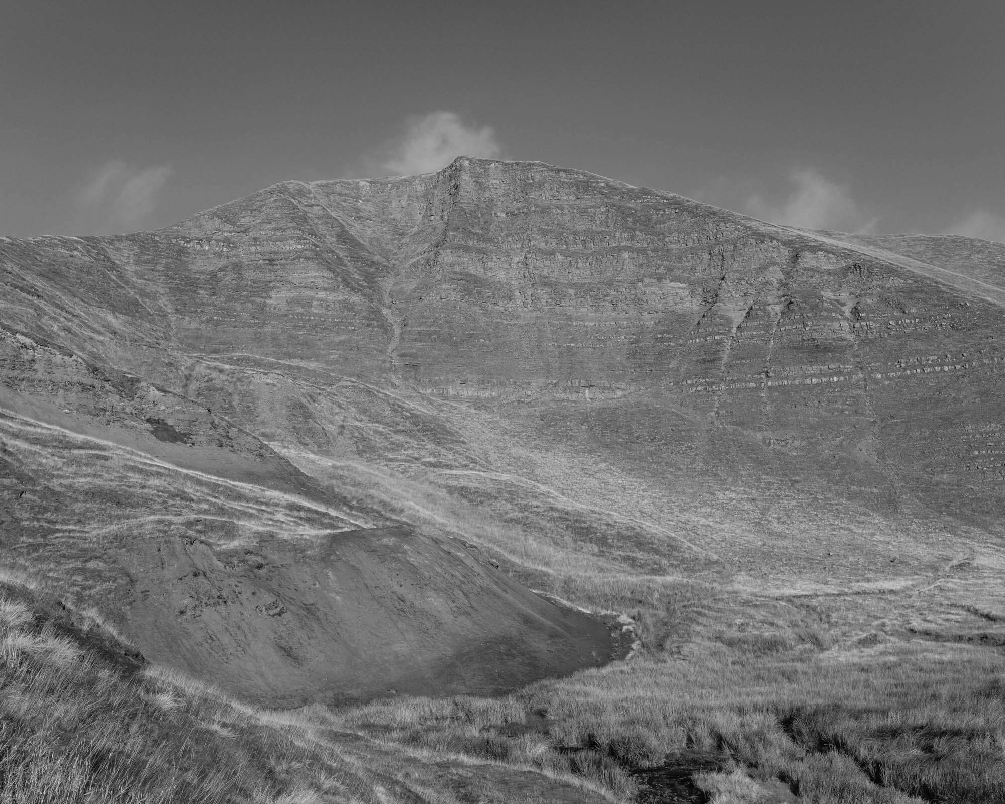 Black and white image of a bare mountain