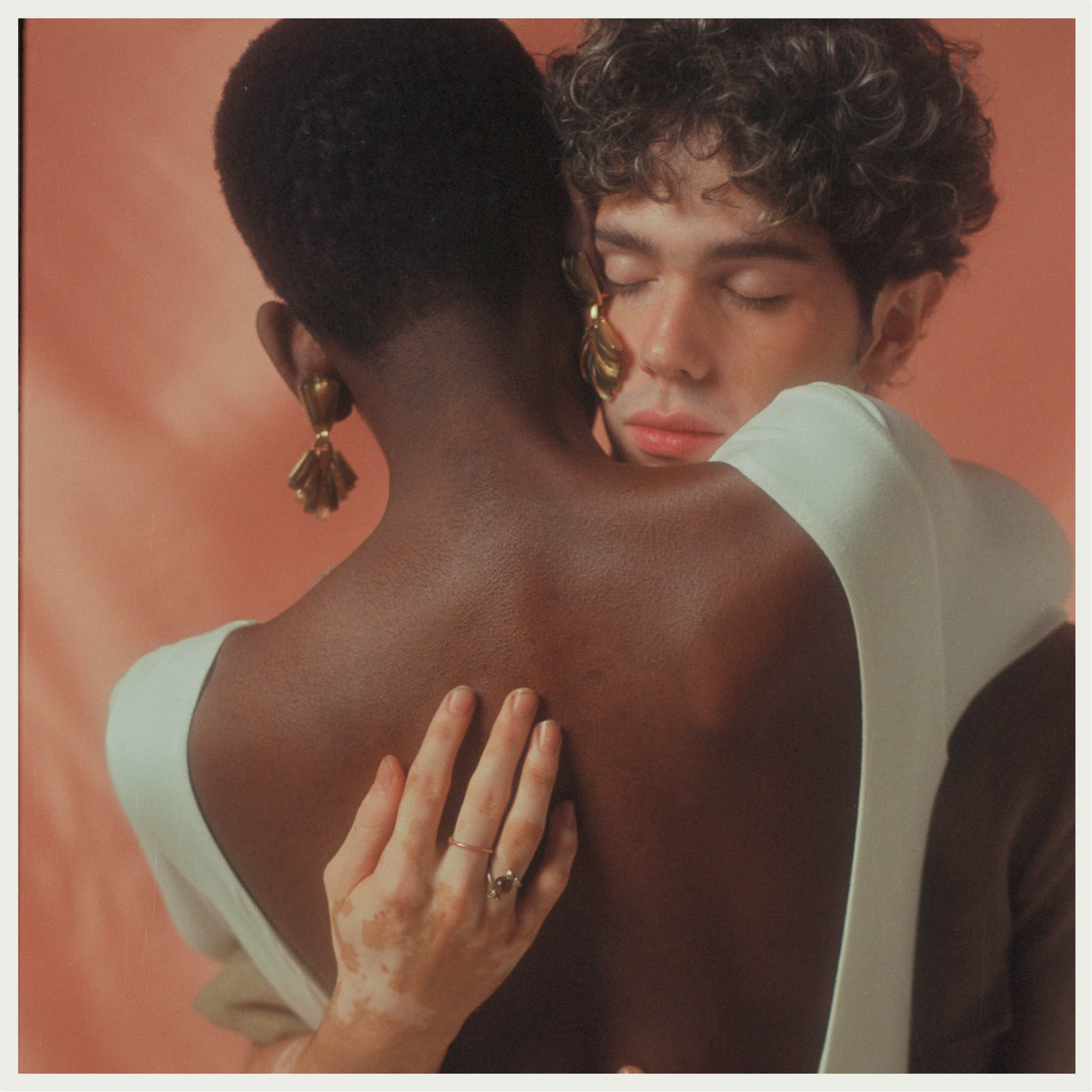 Two models embrace each other with a hug