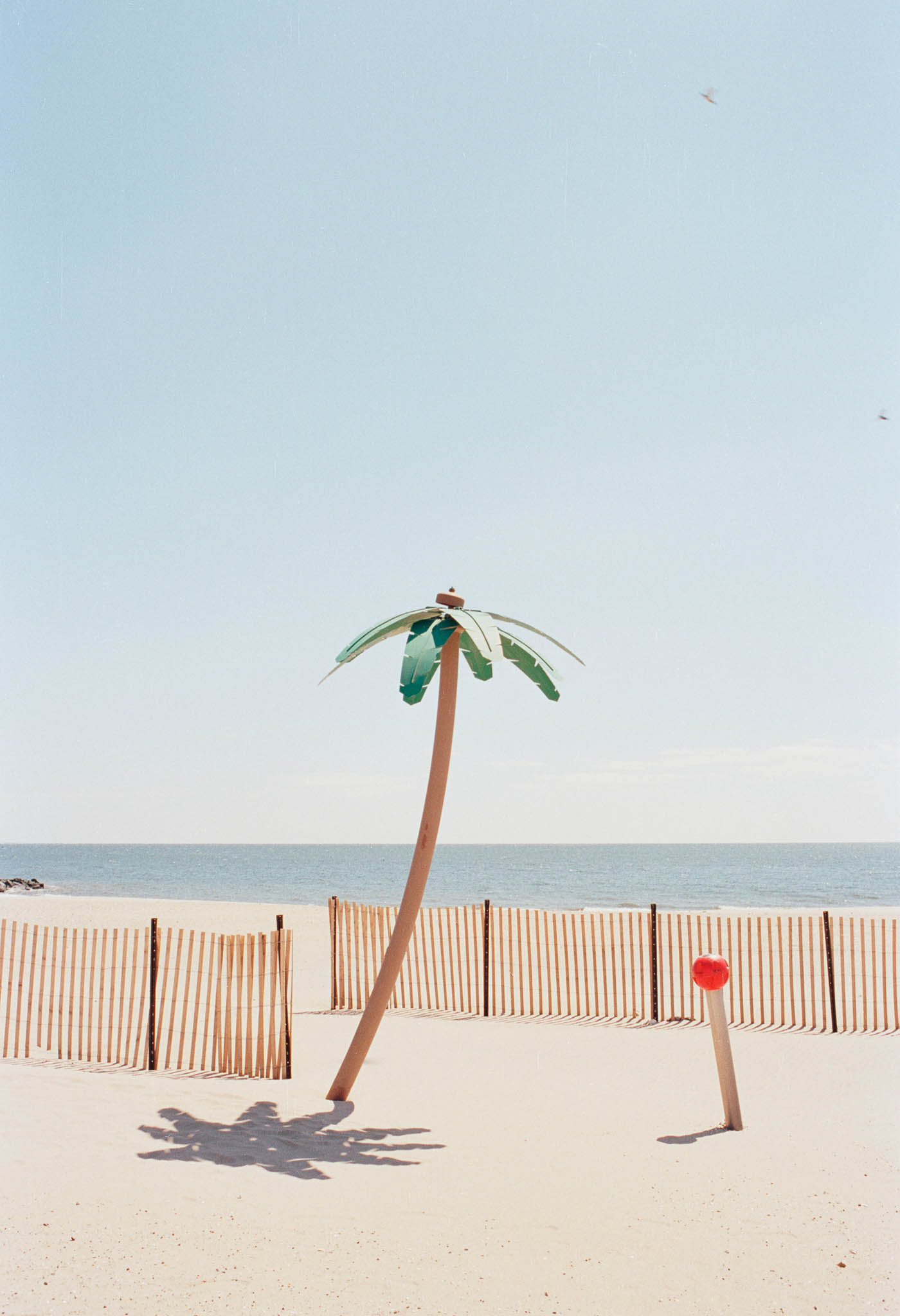 Fake palm tree on a bright beach