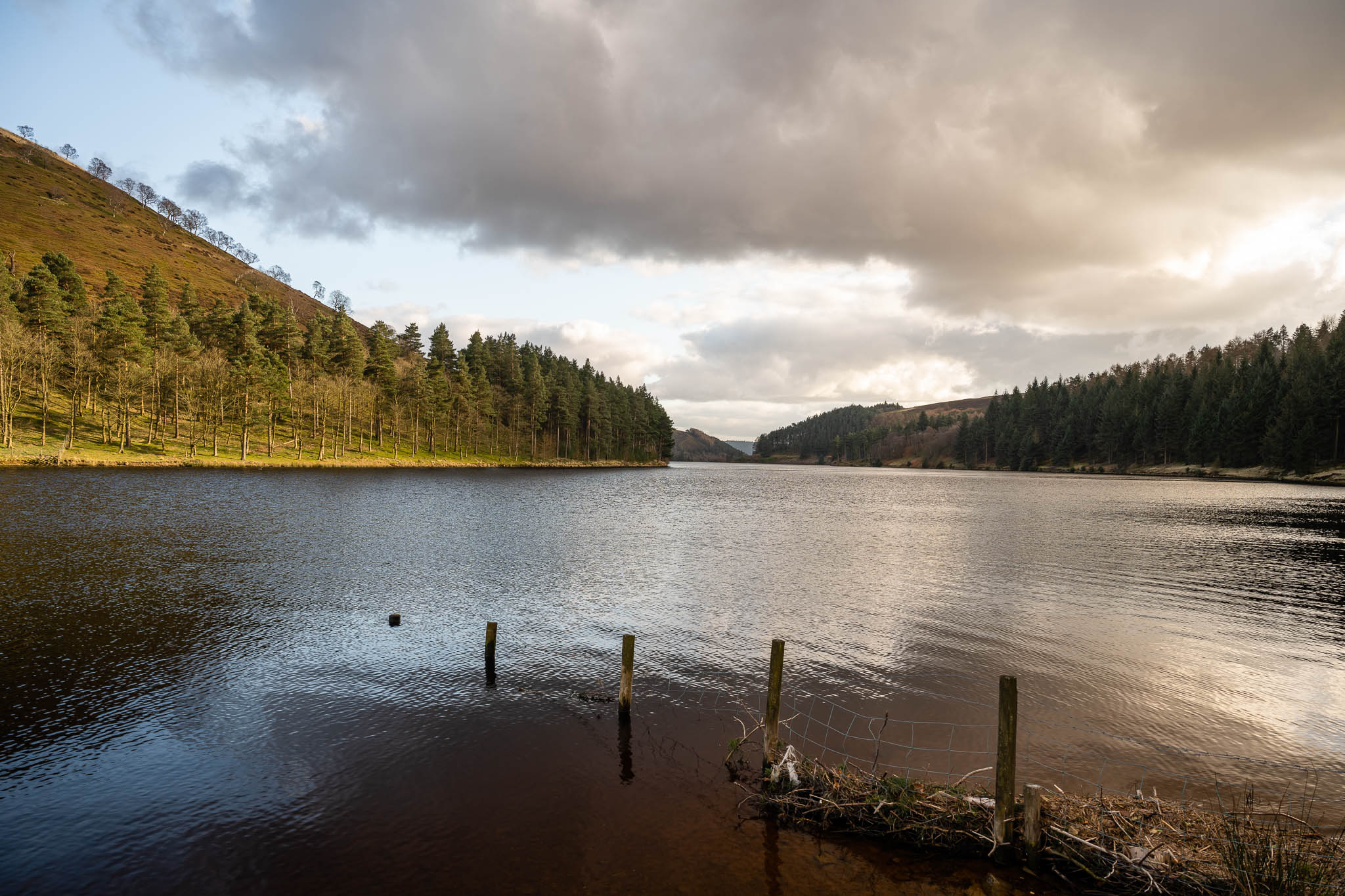 a landscape photo of a lake and hills