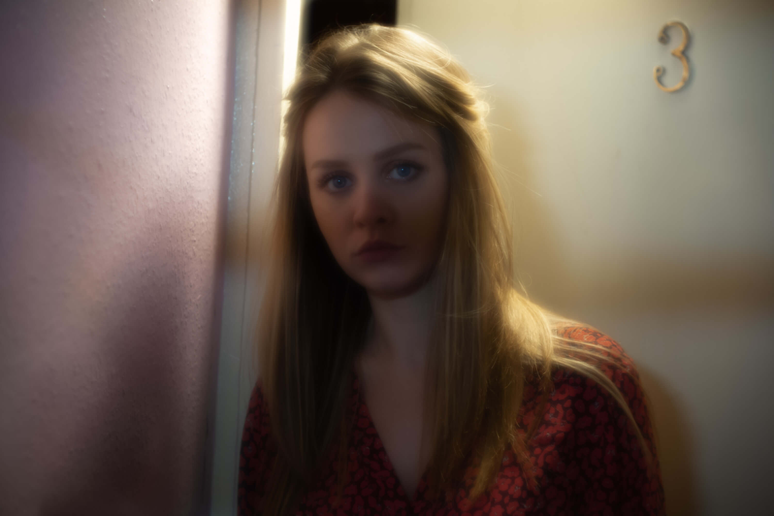 Lady standing outside a front door in the dark