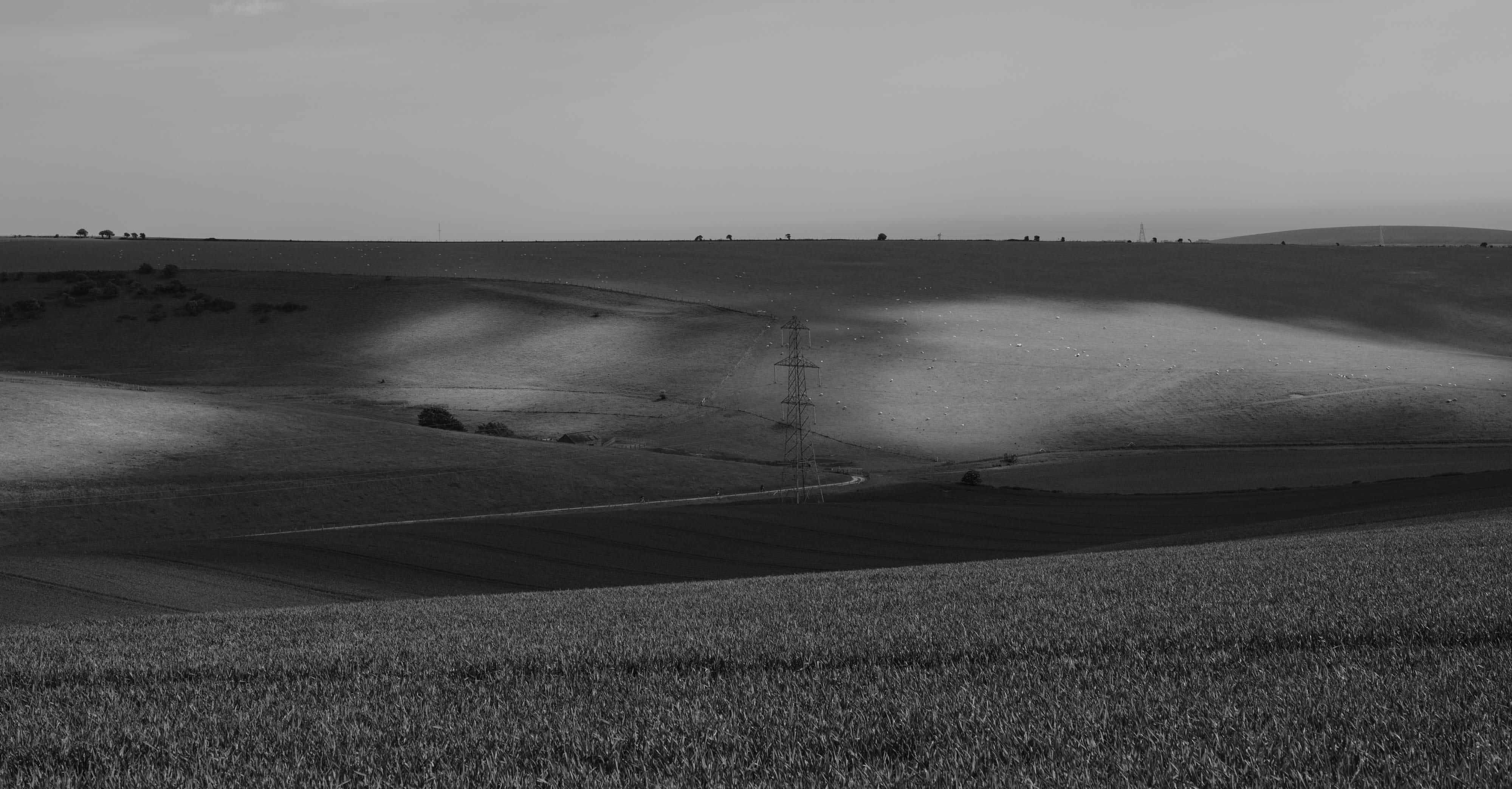Black and white landscape image of hills and power lines. Shot with Fuji GFX100.