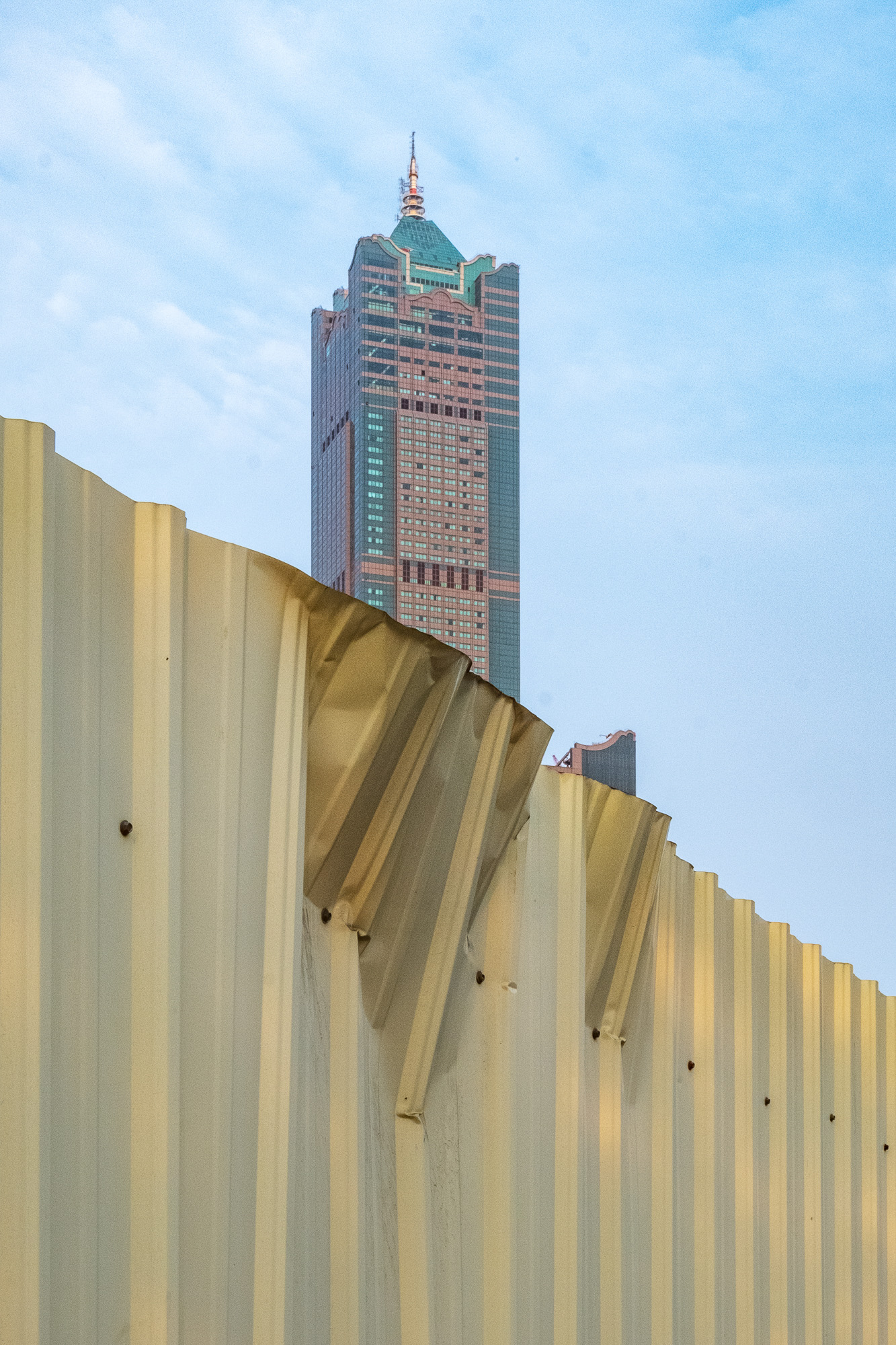 Huge tower in the background with a golden fence in the foreground