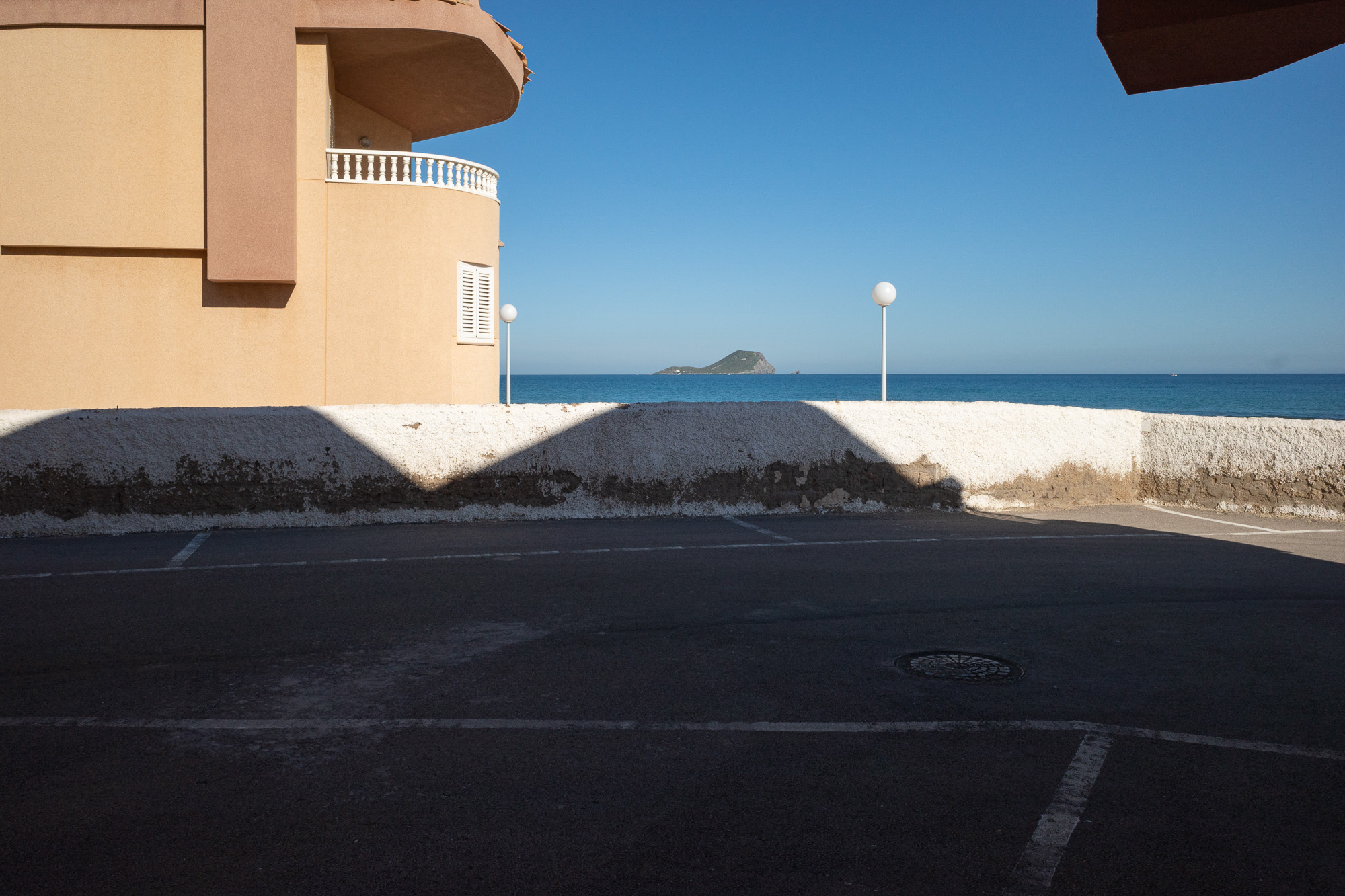 An island in the distance lines up perfectly with the shadows in the foreground