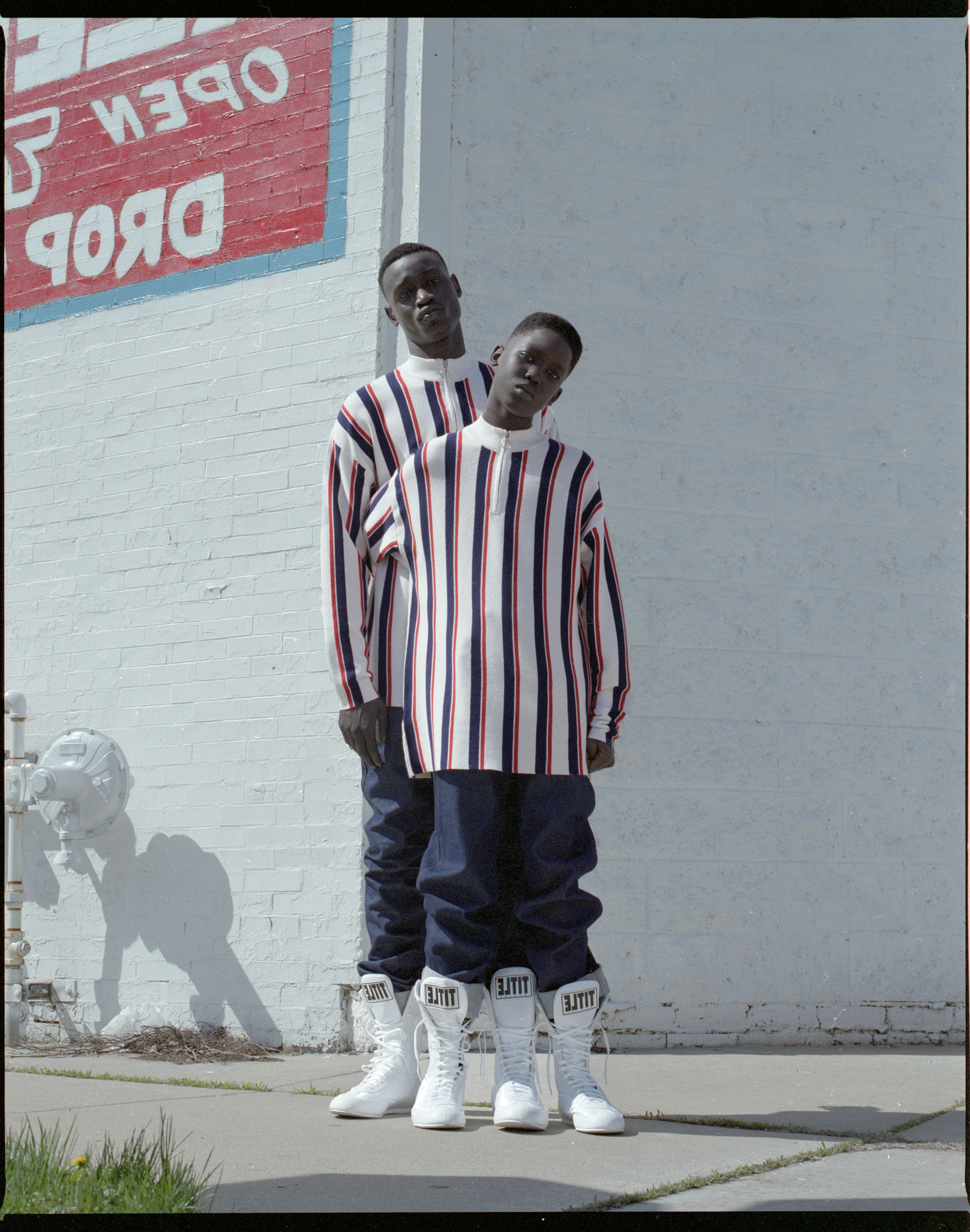 Two people pose together on the street